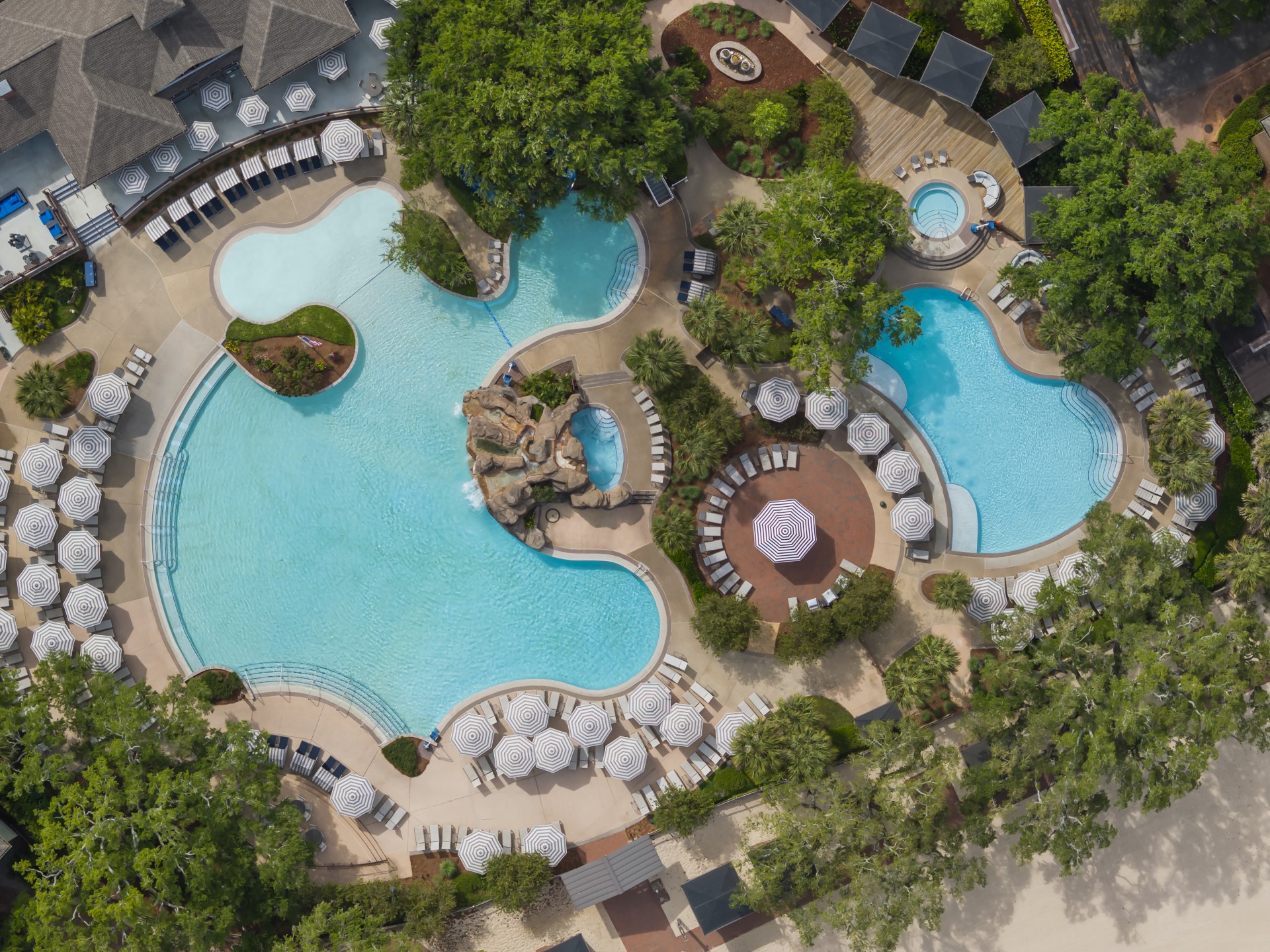a swimming pool with chairs and trees