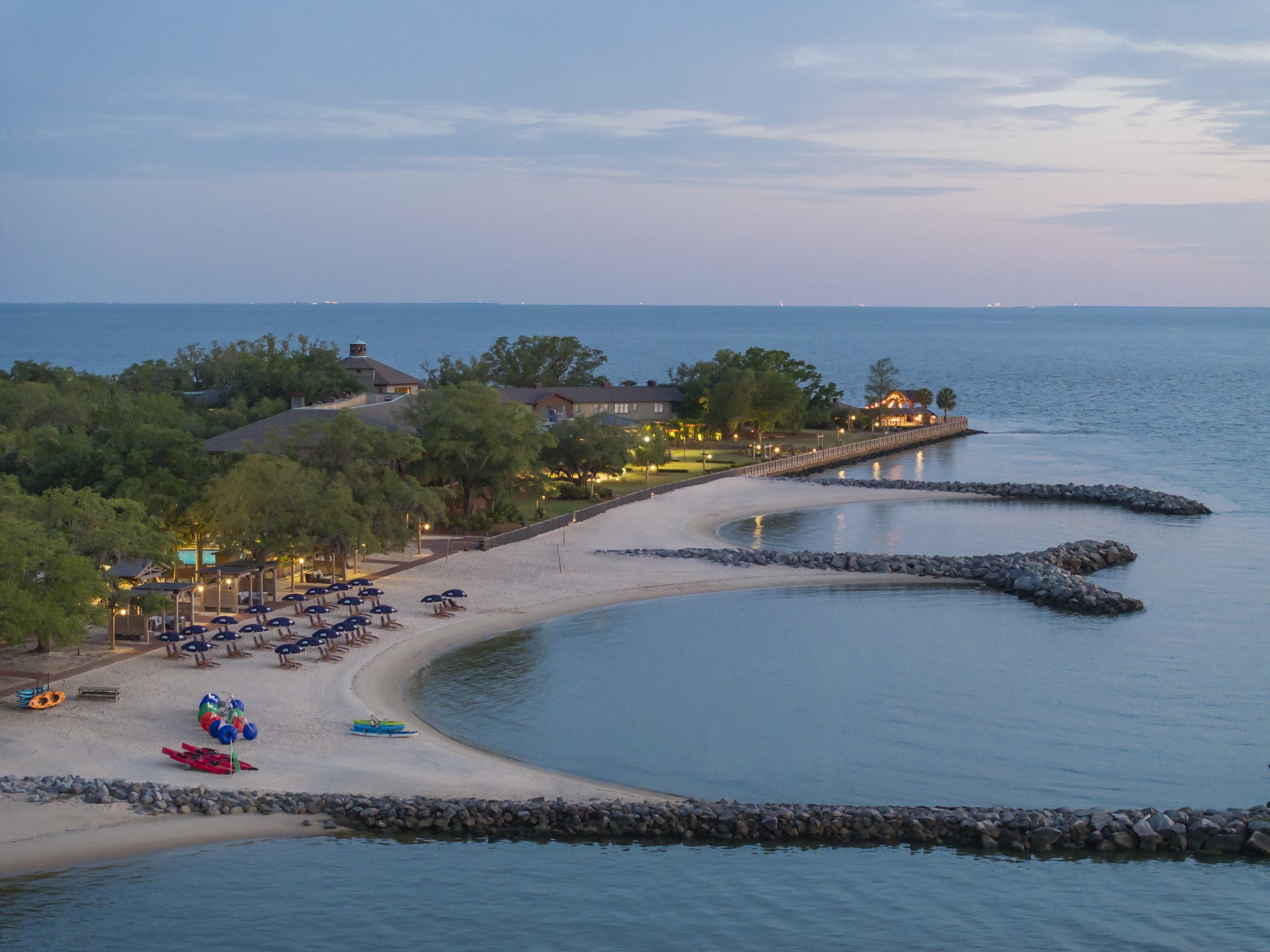 a beach with chairs and a body of water