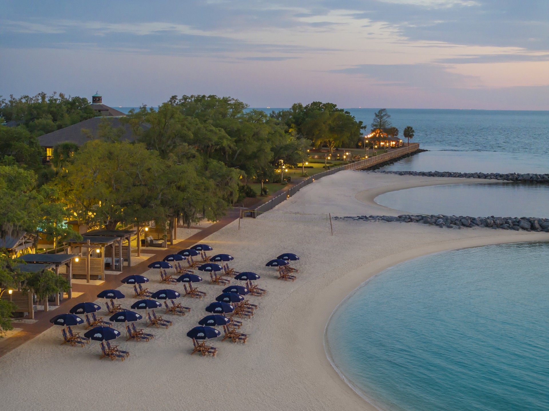 a beach with umbrellas and chairs