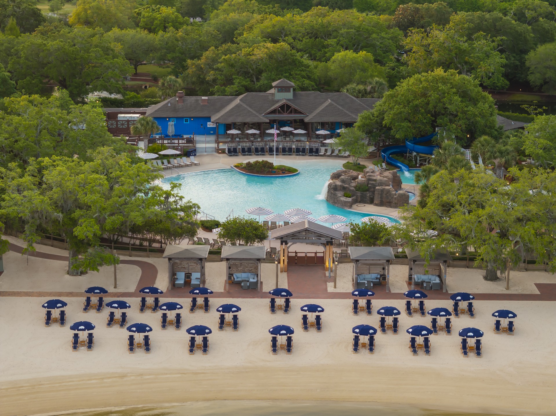 a pool and chairs on a beach