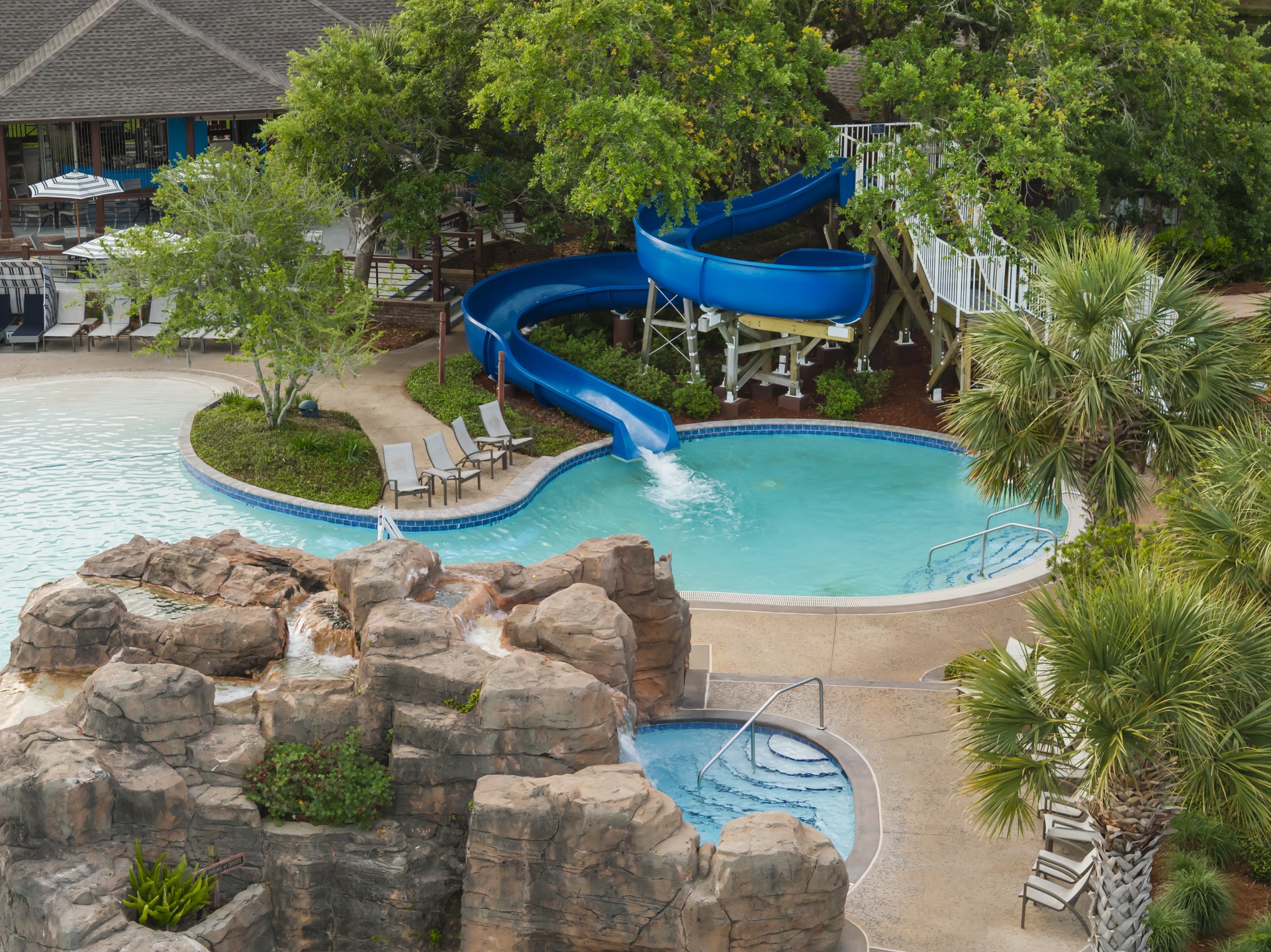 a pool with a slide and a slide in it