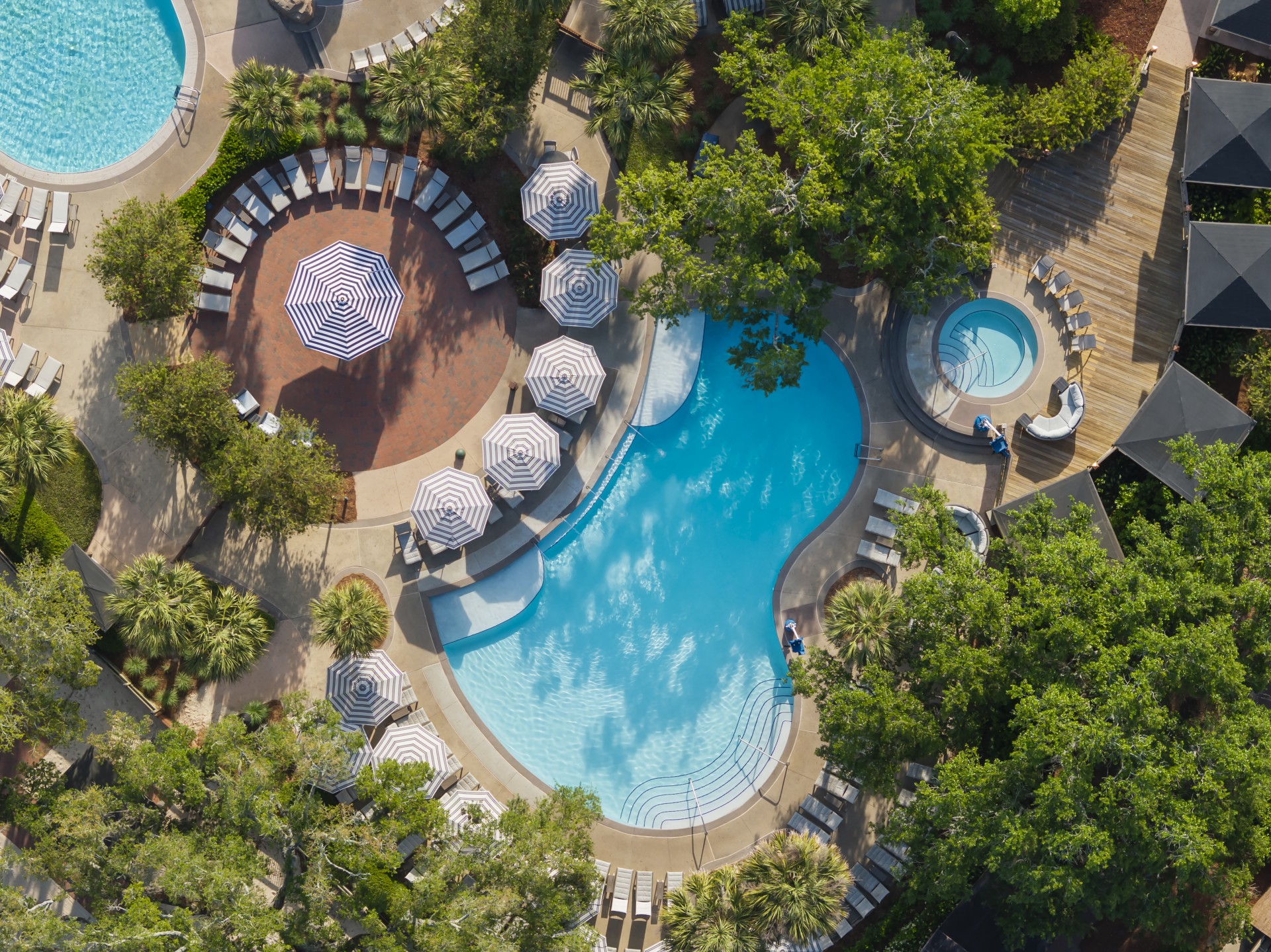 an aerial view of a pool and trees