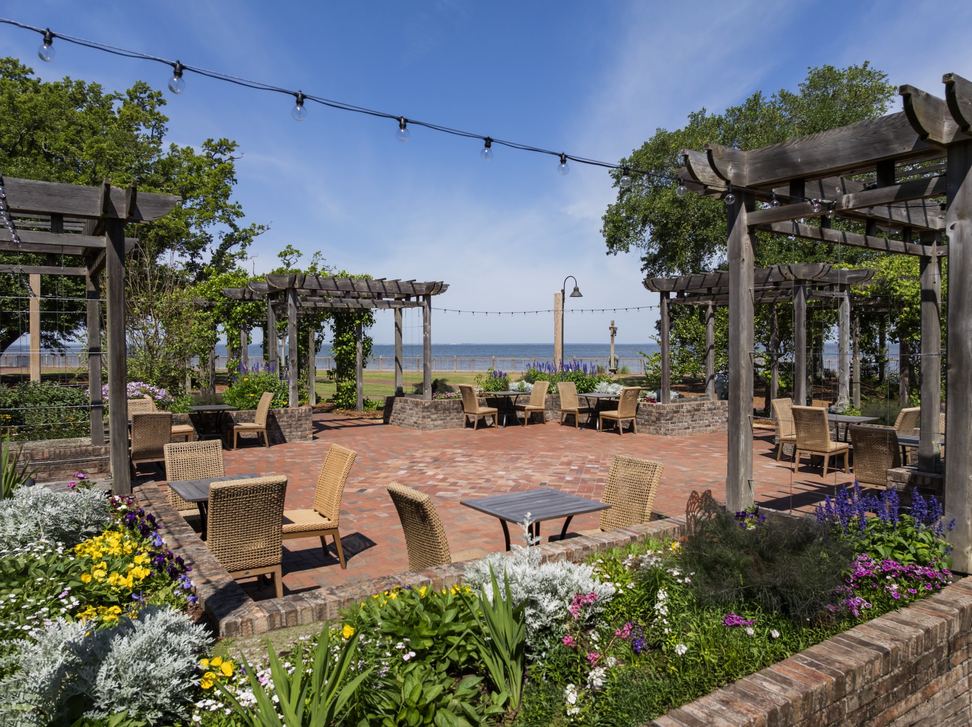a patio with chairs and a pergola