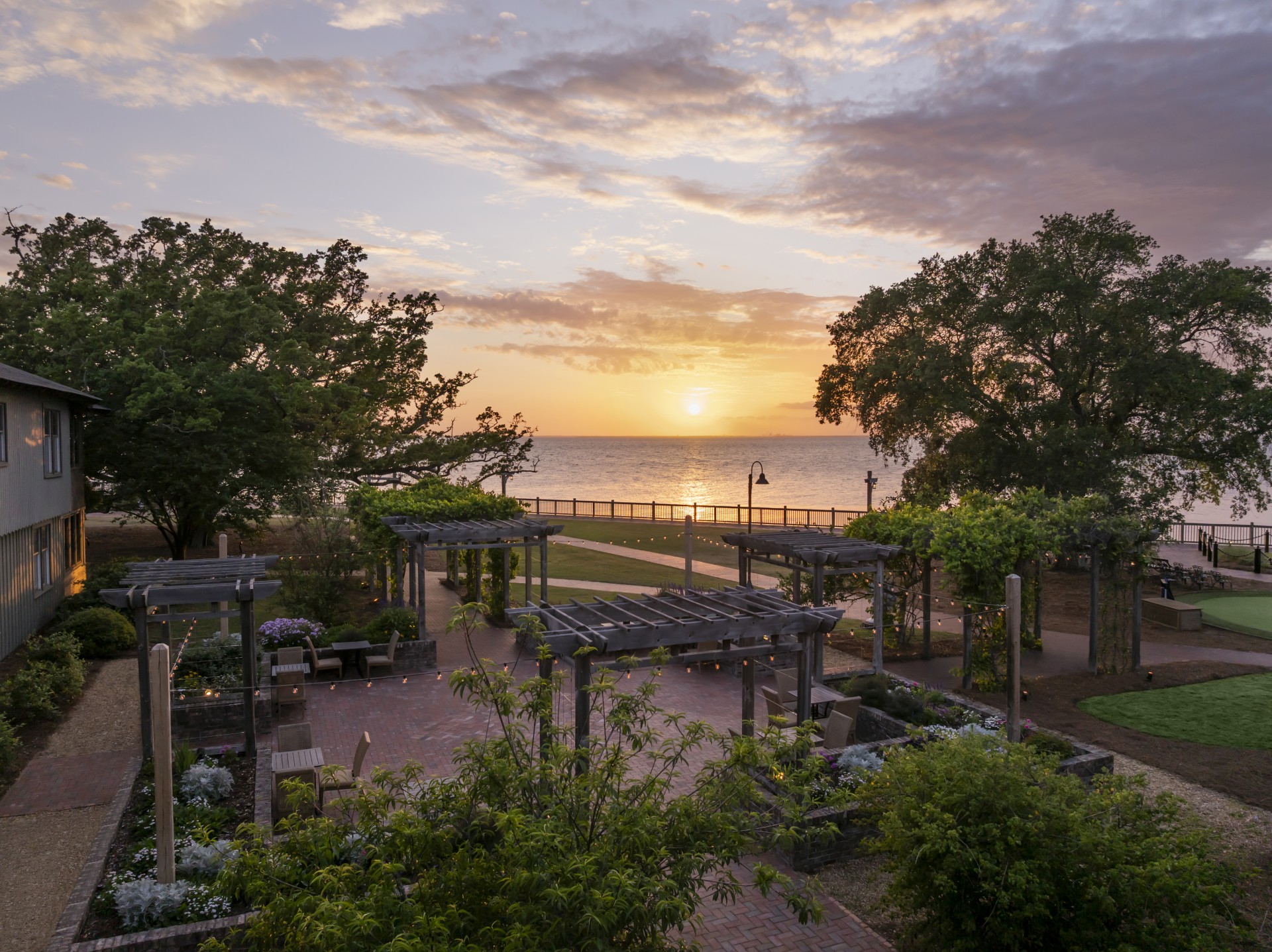 a park with trees and a sunset