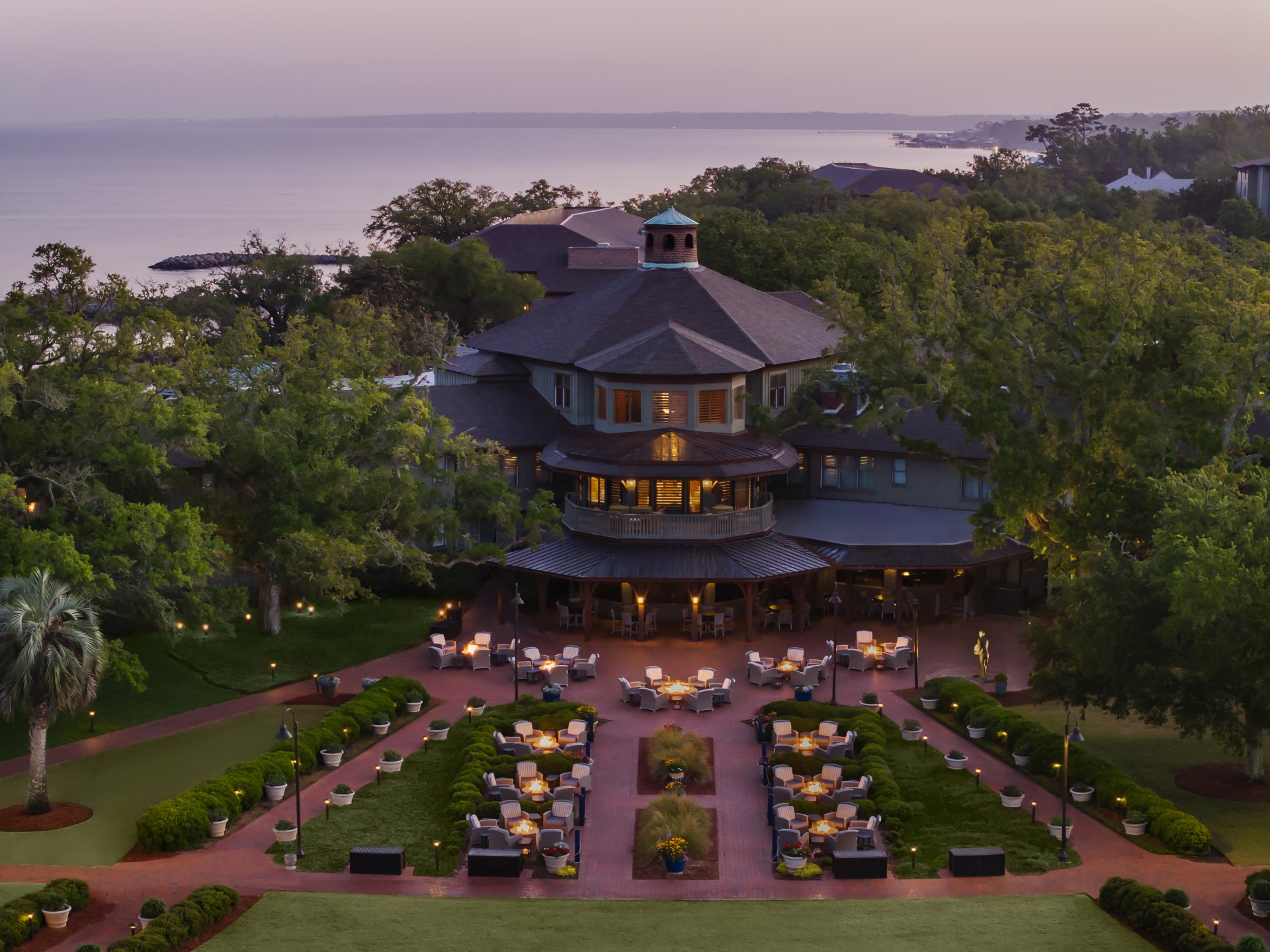a large building with a large lawn and chairs around it