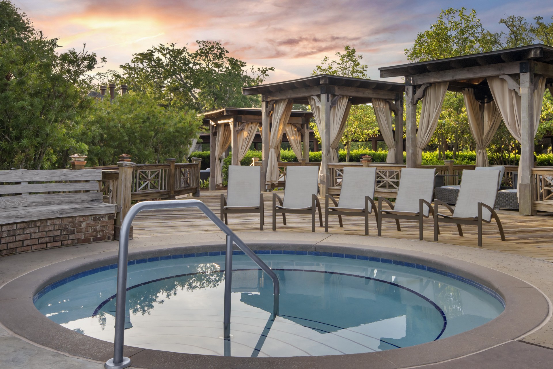 a pool with chairs and a gazebo