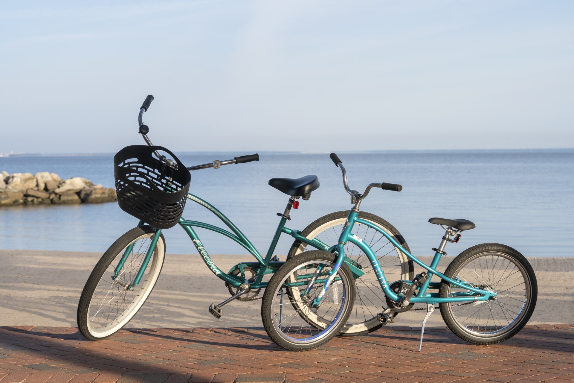 two bicycles parked on a brick surface