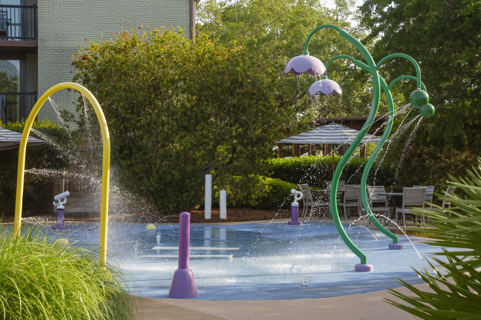 a water park with a pool and water spray
