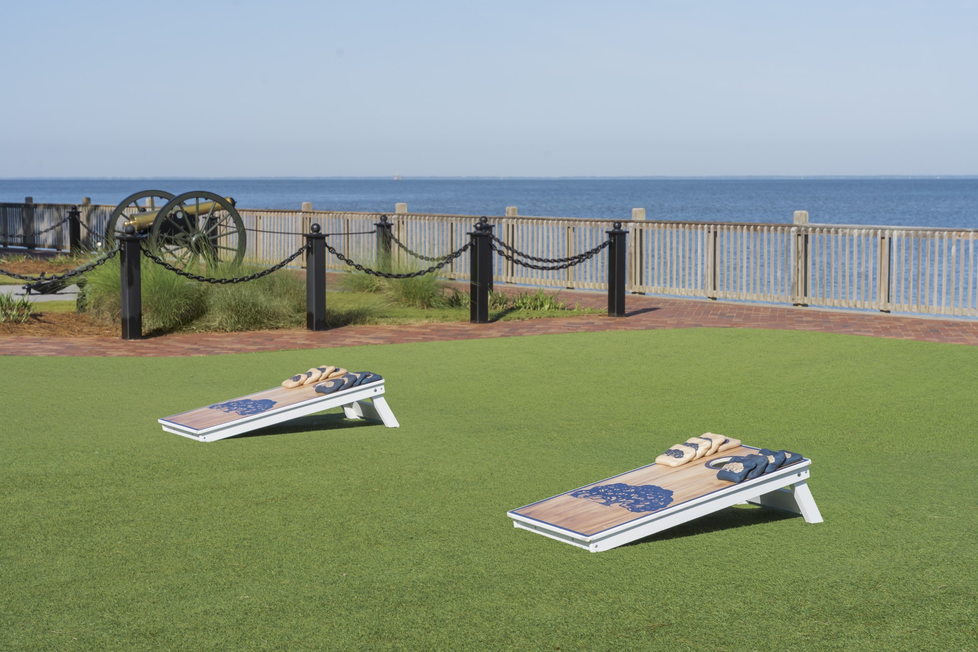 a lawn with chairs and a fence and a railing