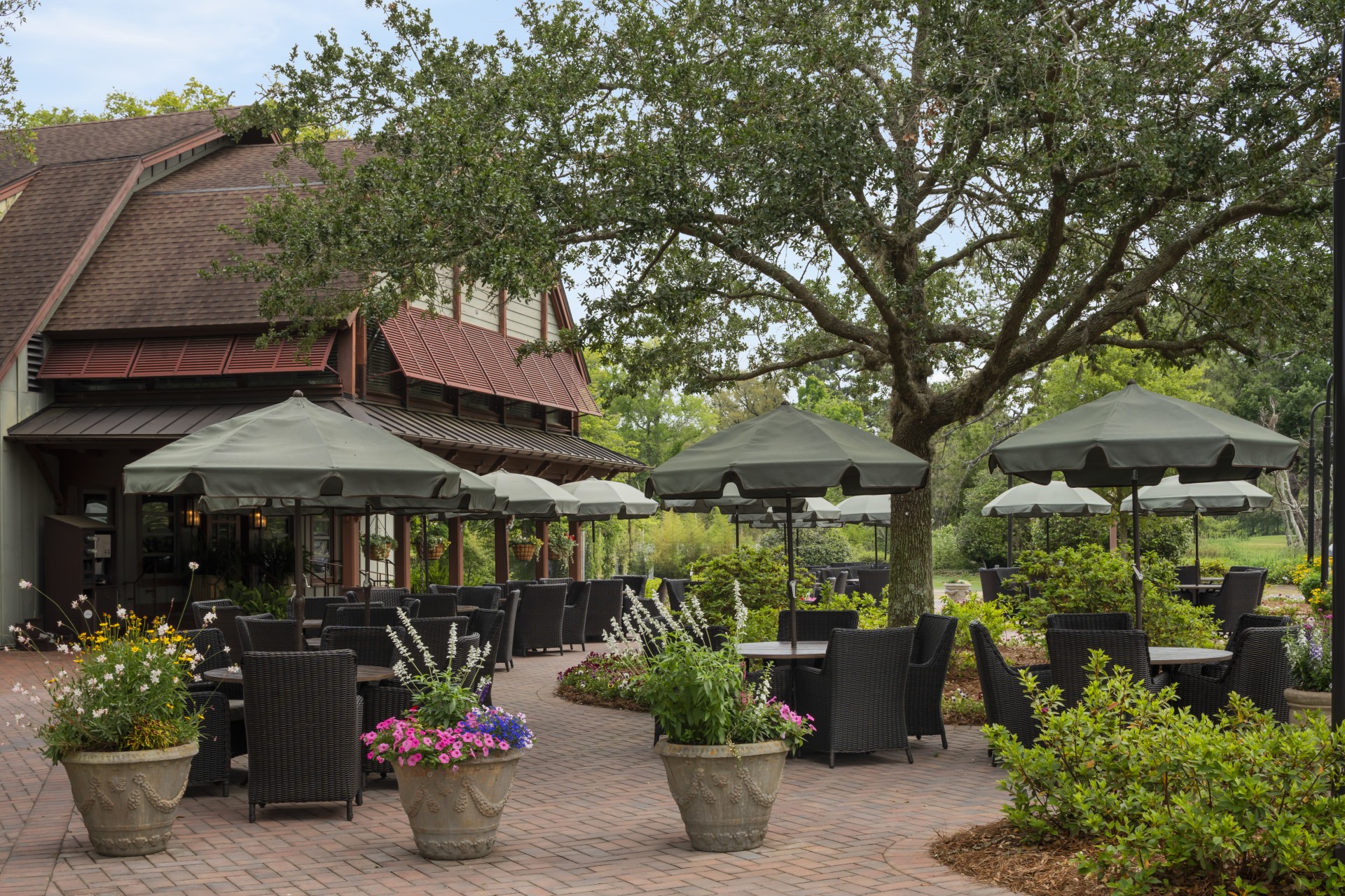 a patio with umbrellas and tables and chairs