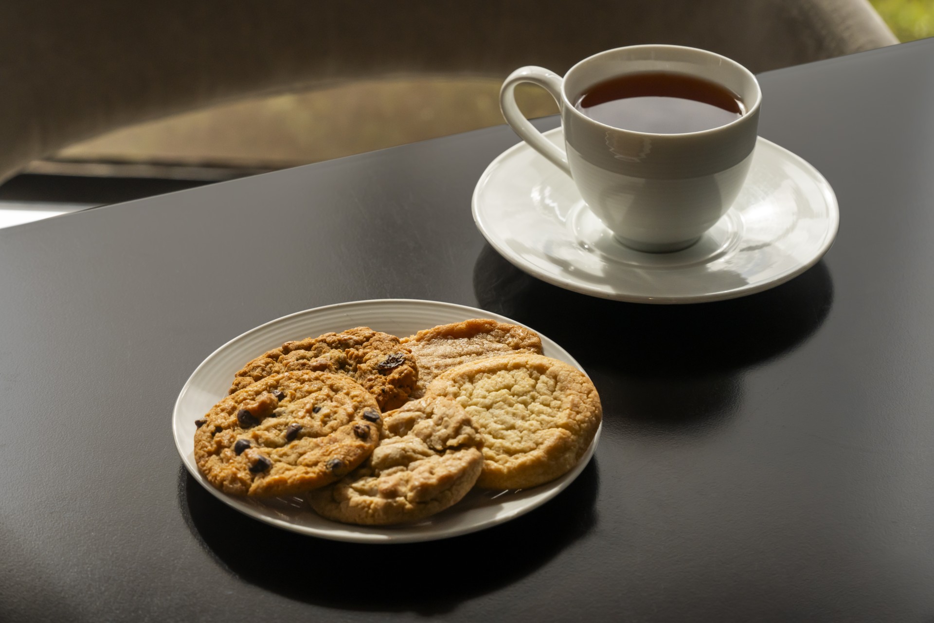 a plate of cookies and a cup of tea