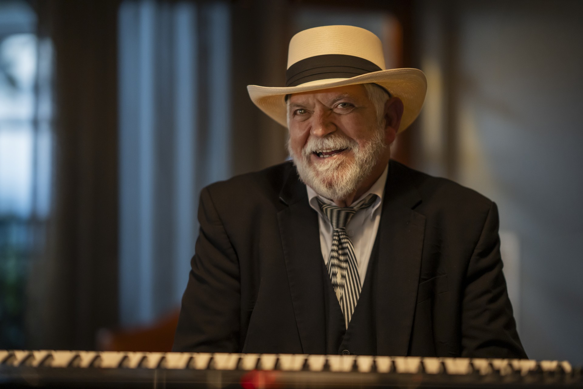 a man in a hat and suit