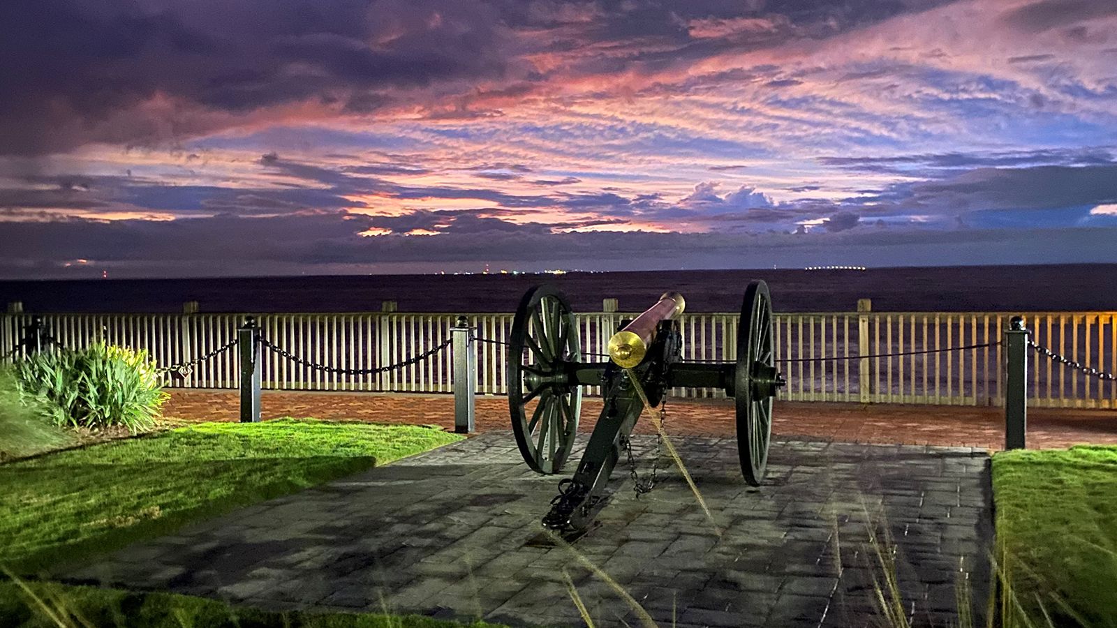 a cannon on a brick walkway