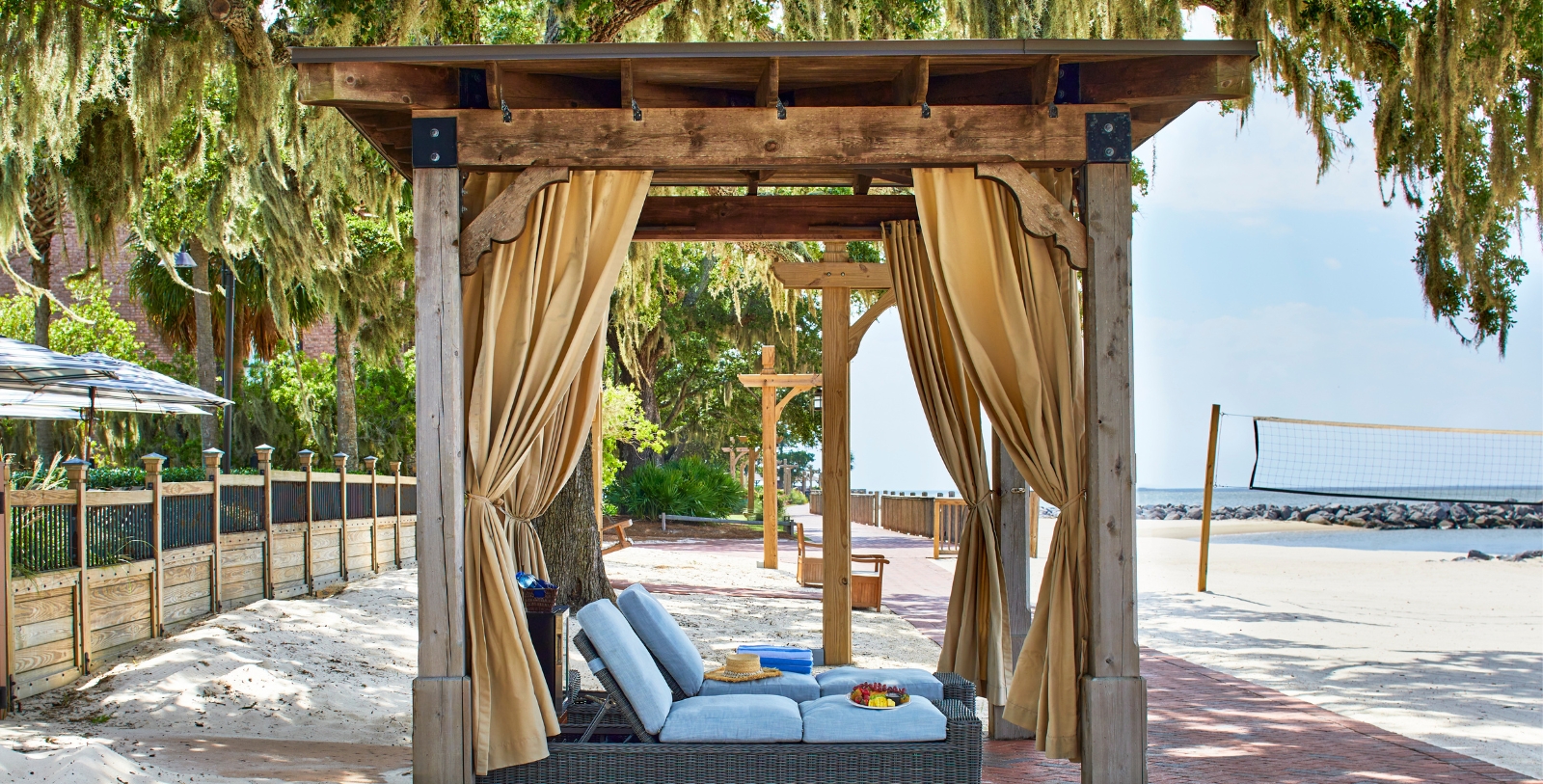 a wooden structure with a bench and a table with a table and a chair
