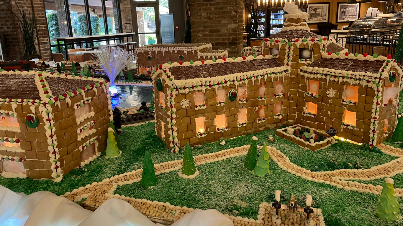 a gingerbread castle with trees and lights