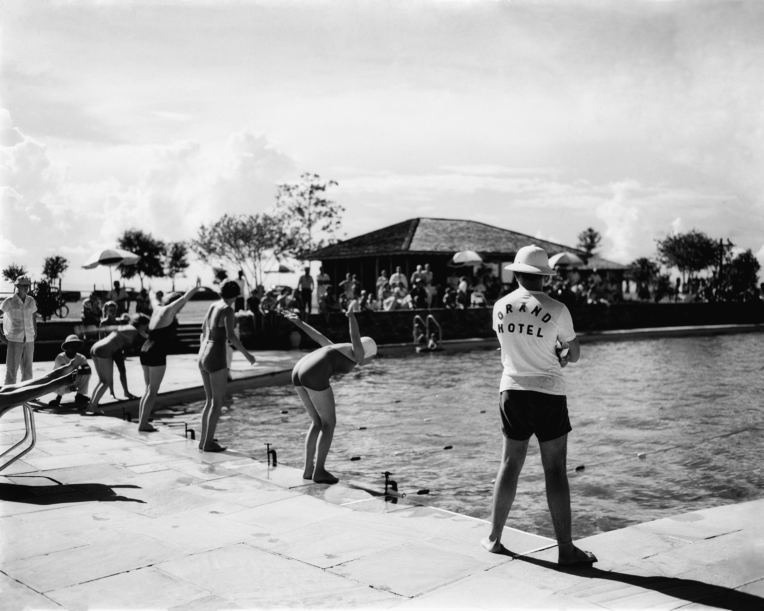 a group of people standing near a pool