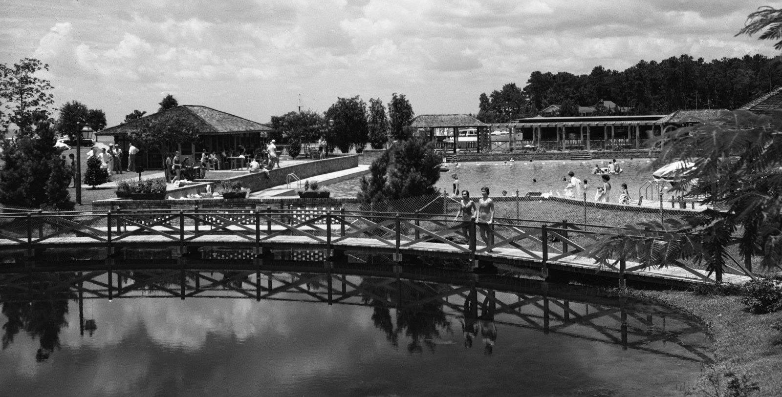 a group of people on a bridge over a body of water