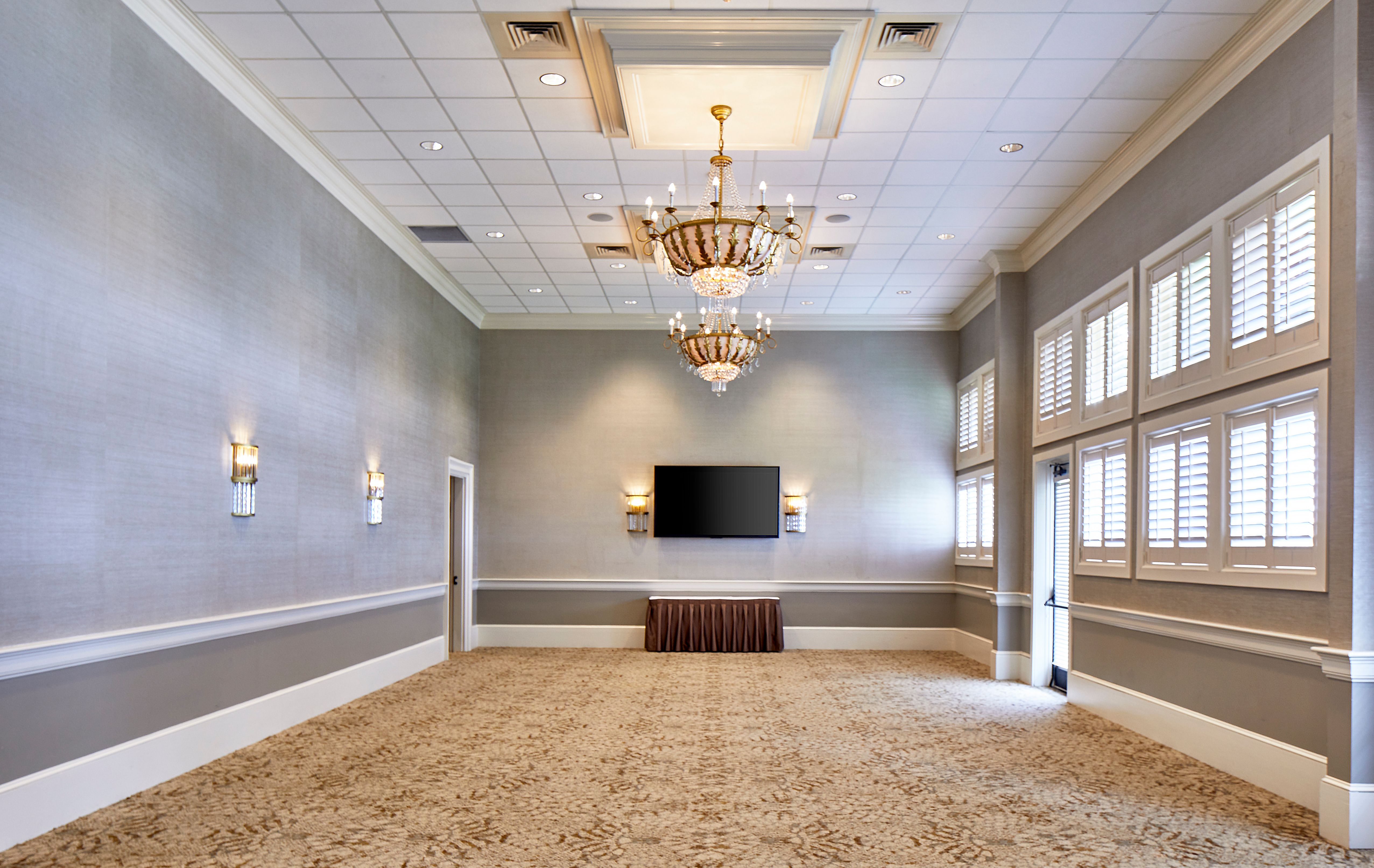 a room with a chandelier and a television