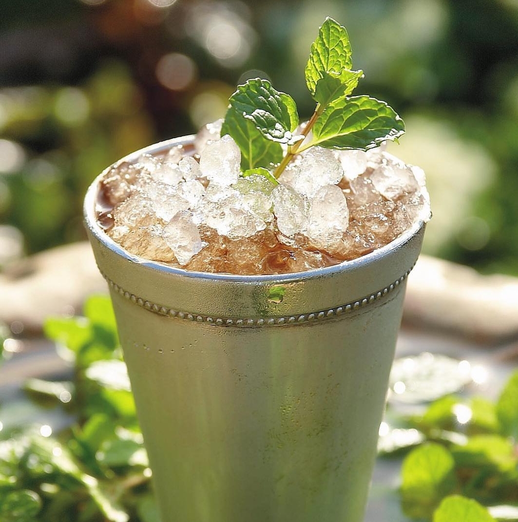 a cup with ice and mint leaves