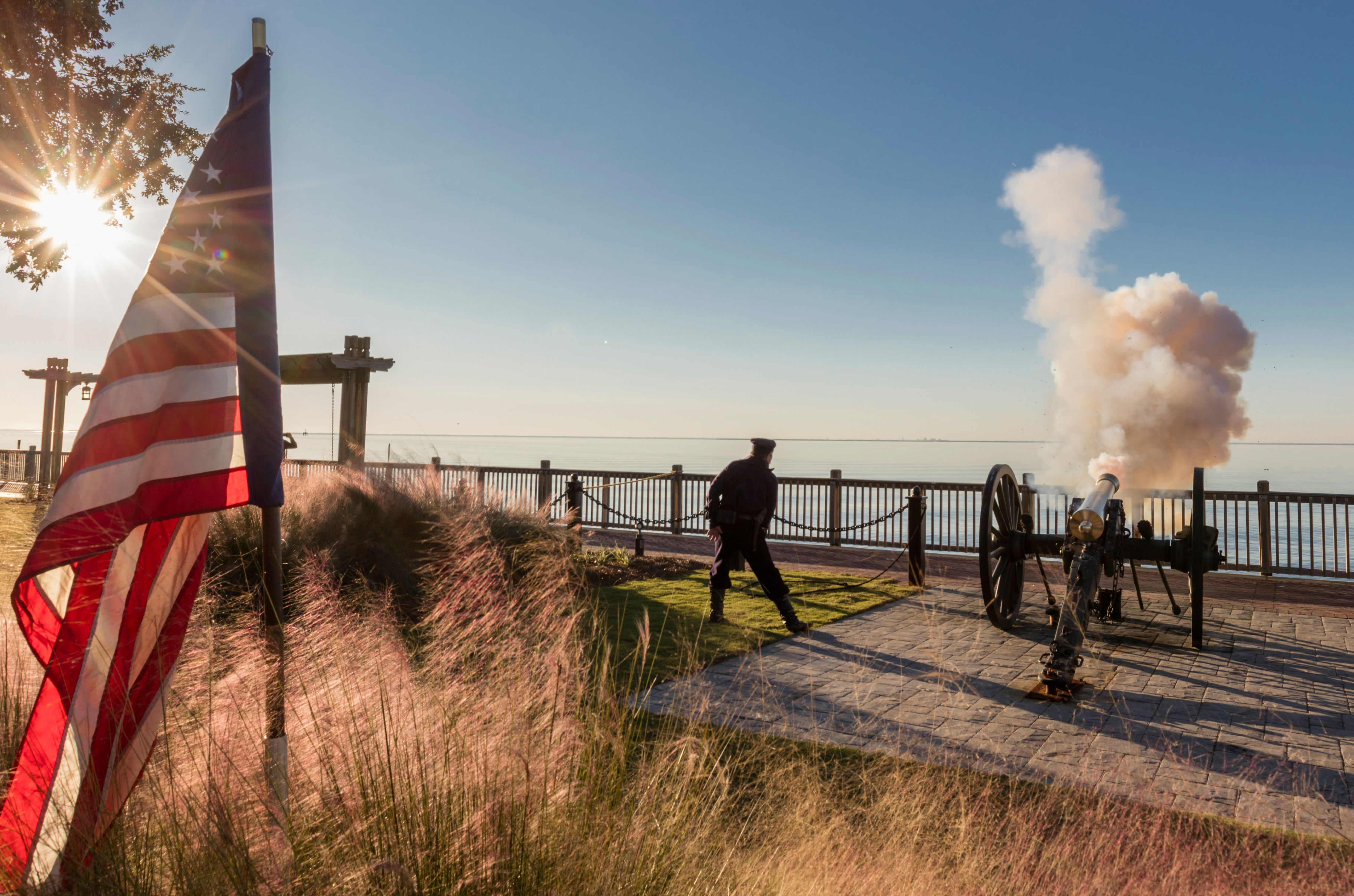 a man walking next to a cannon