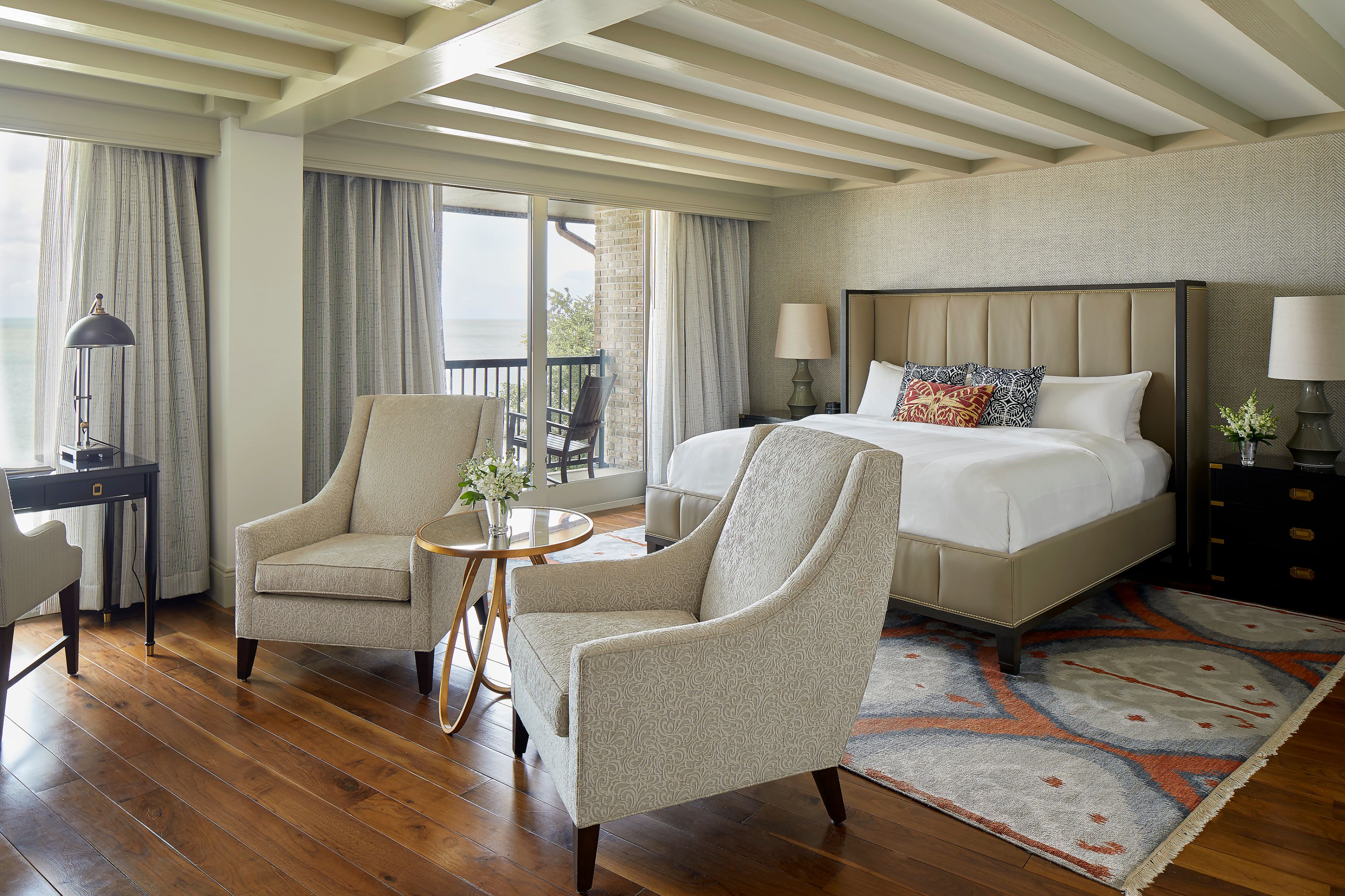 a bedroom with a bed and chairs