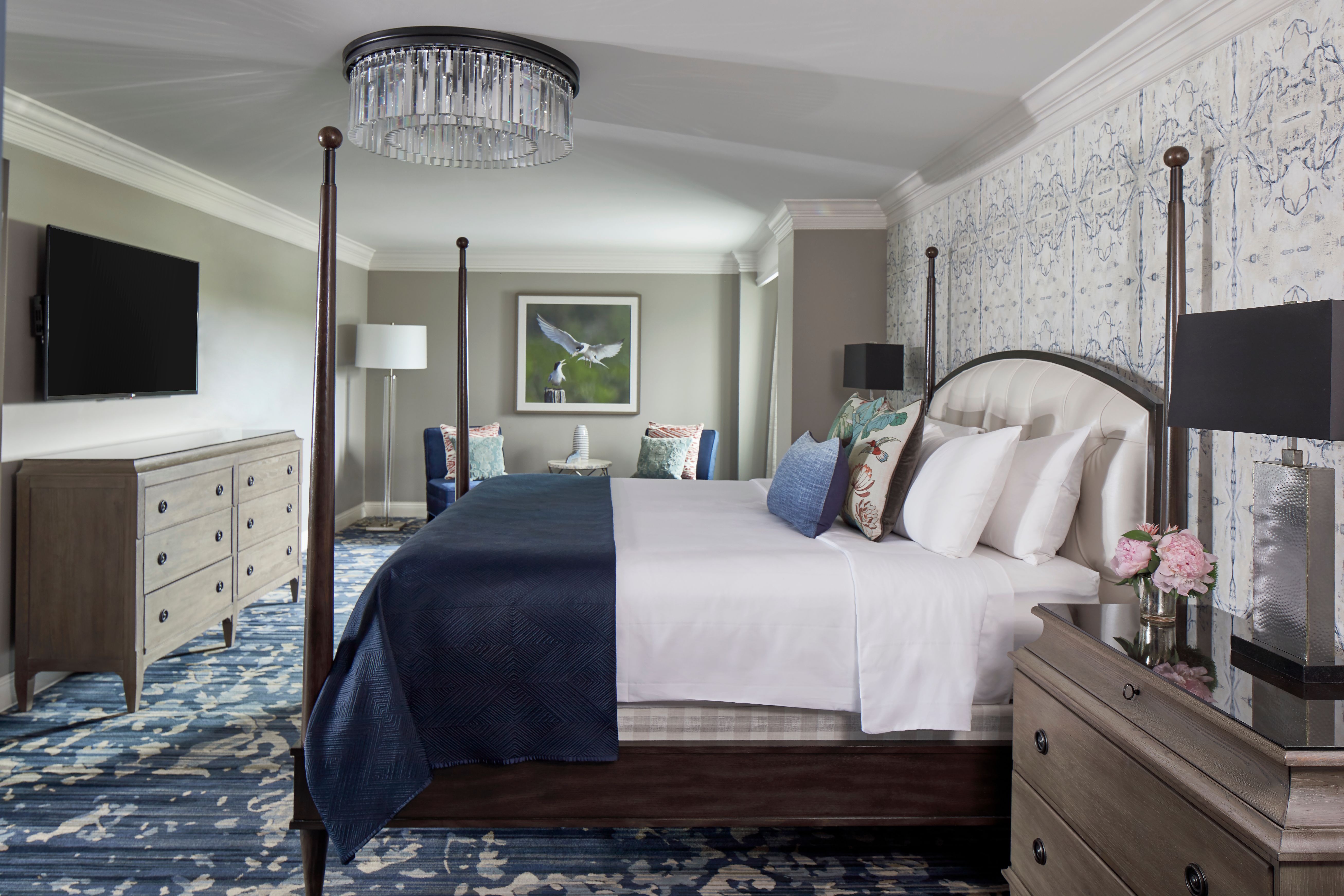 a bedroom with a bed and a chandelier