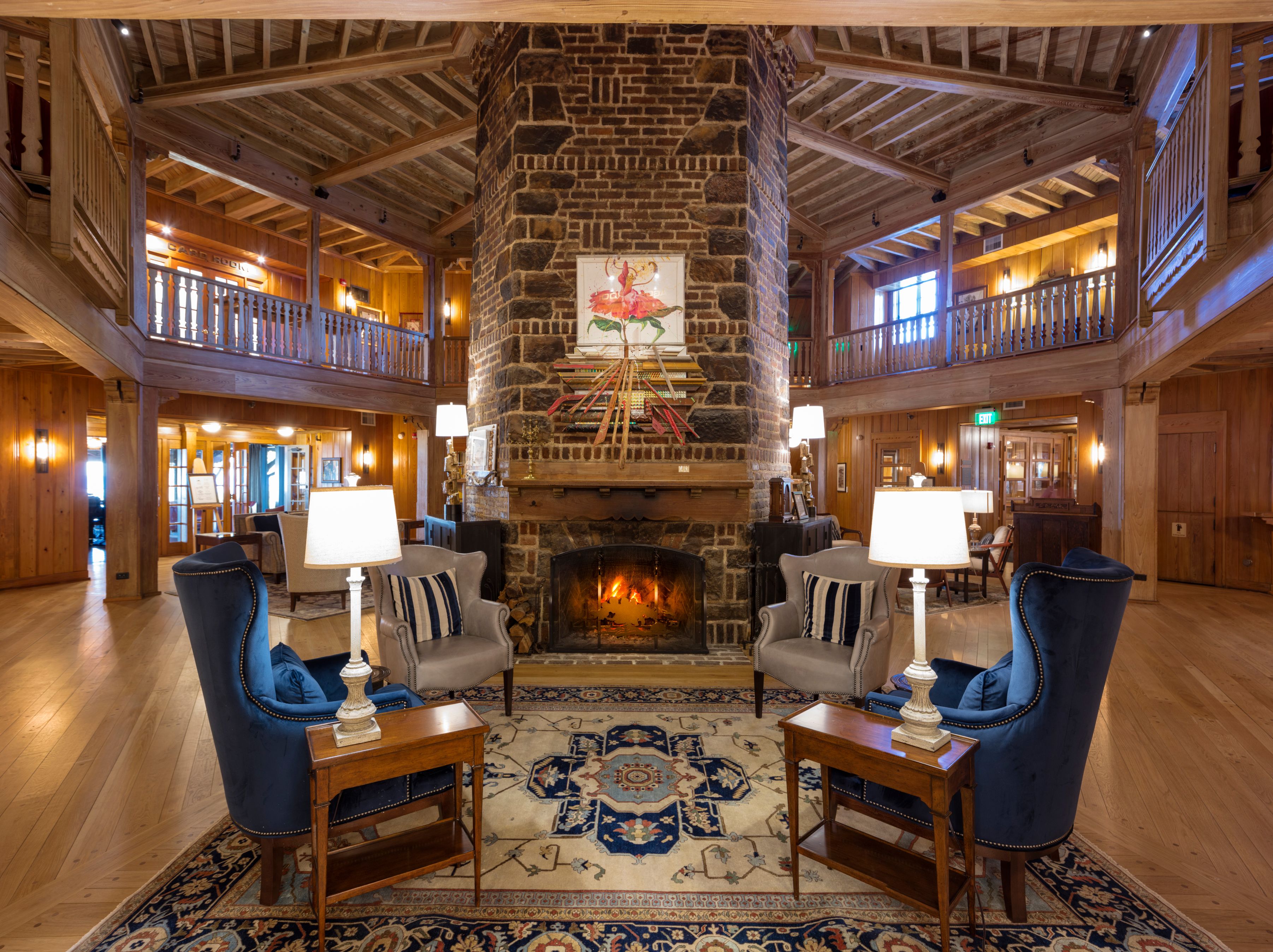 a room with a fireplace and chairs