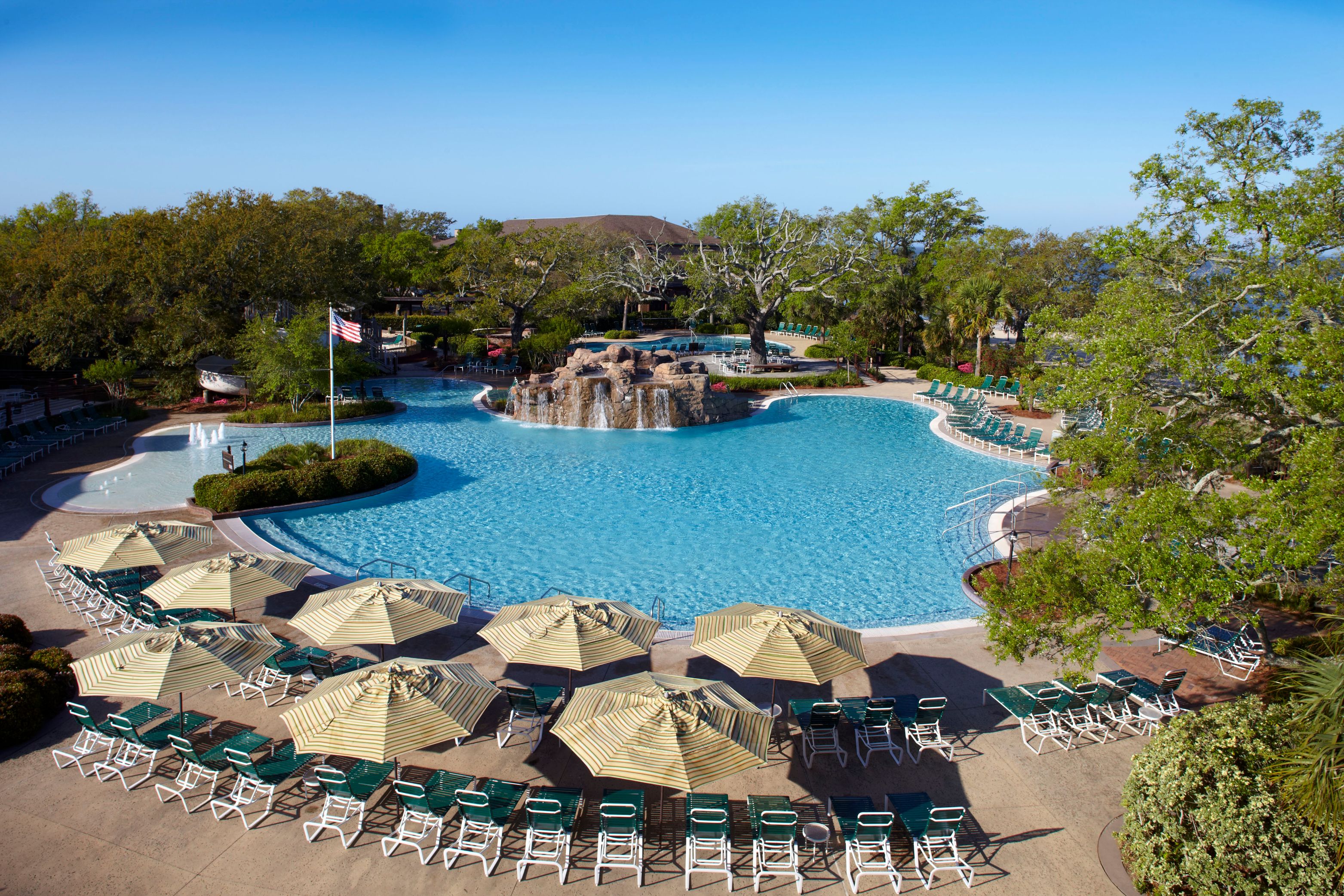 a pool with umbrellas and chairs