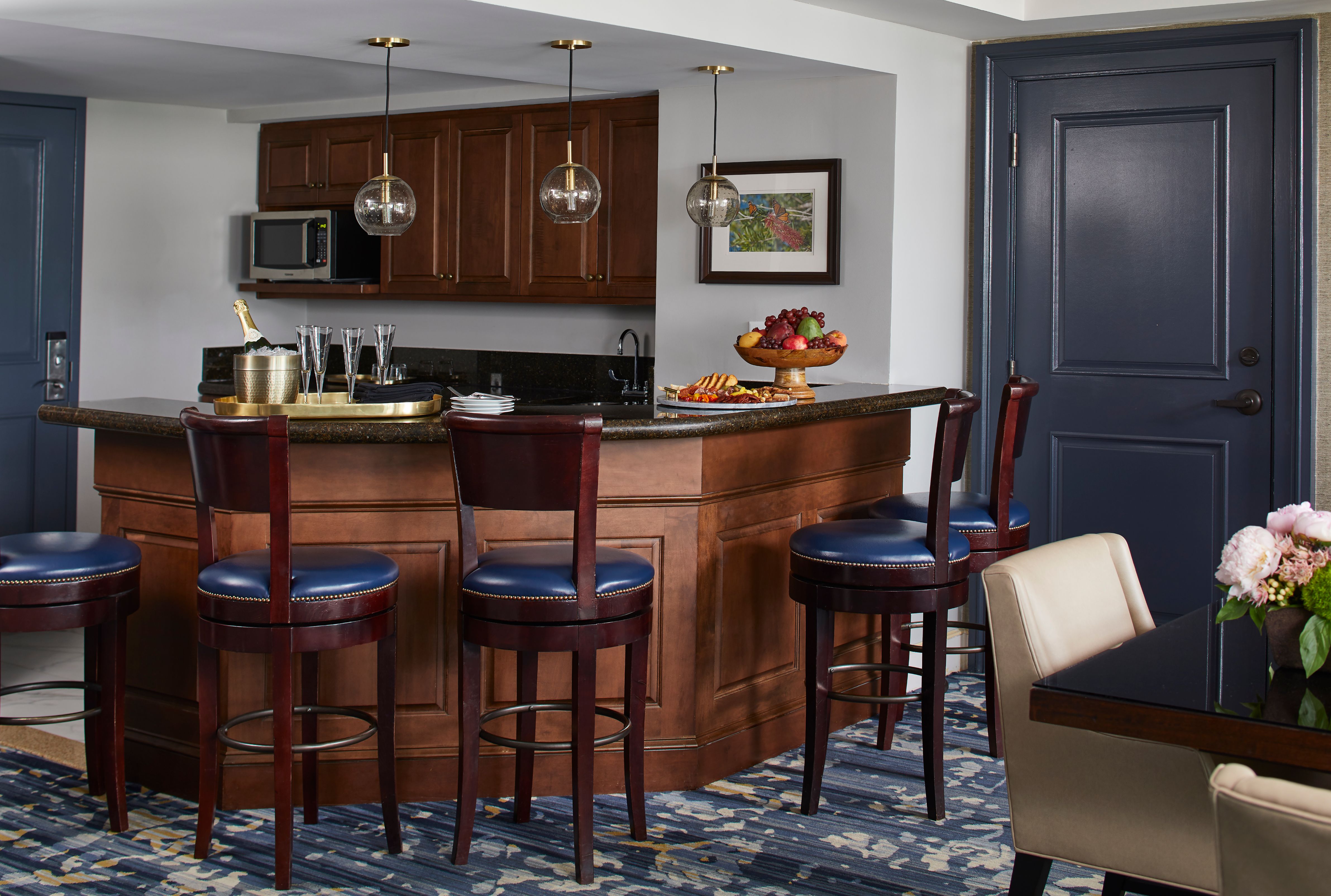 a kitchen with a bar and chairs
