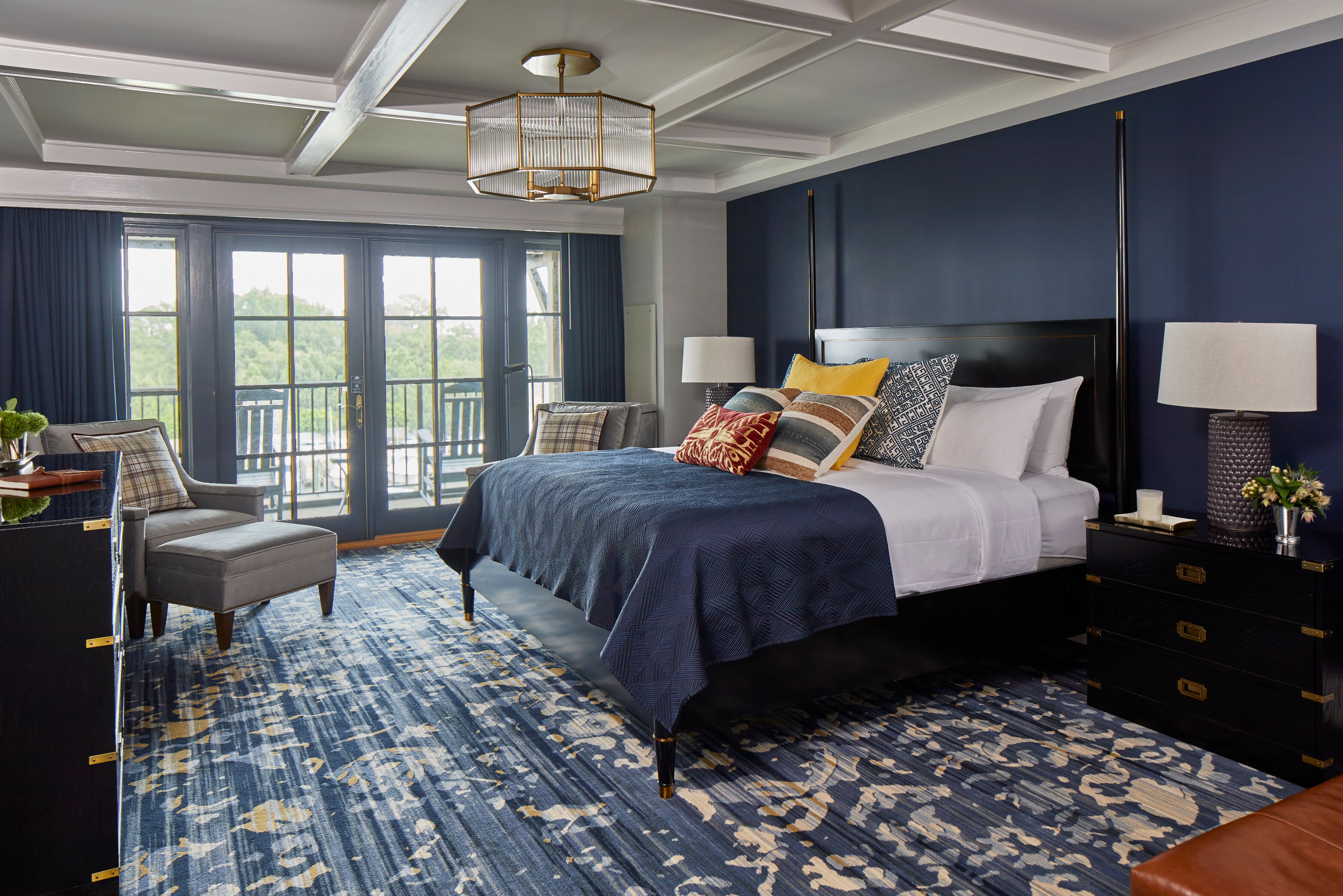 a bedroom with a blue carpet and a blue bed