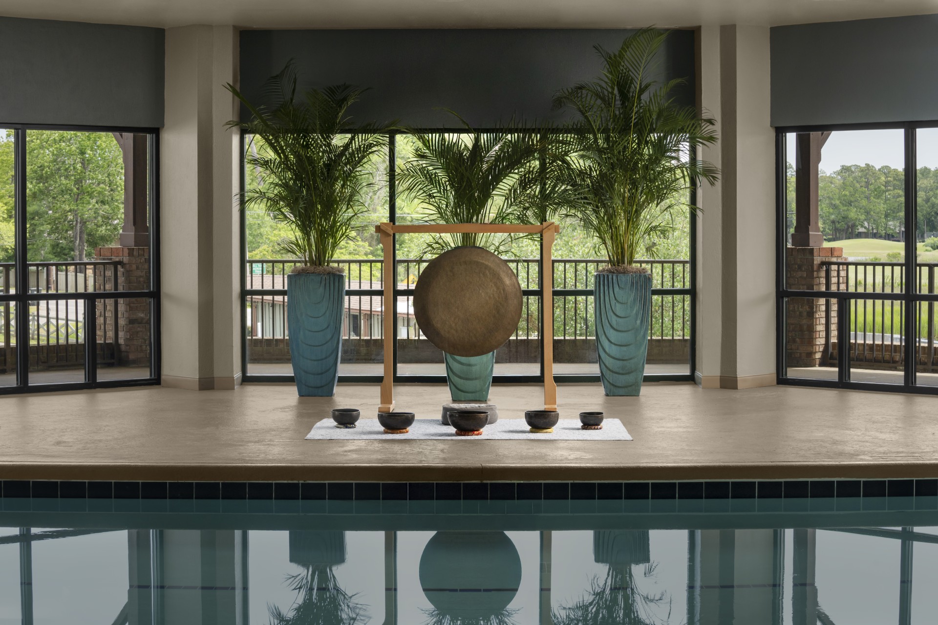 a pool with a large gong and palm trees