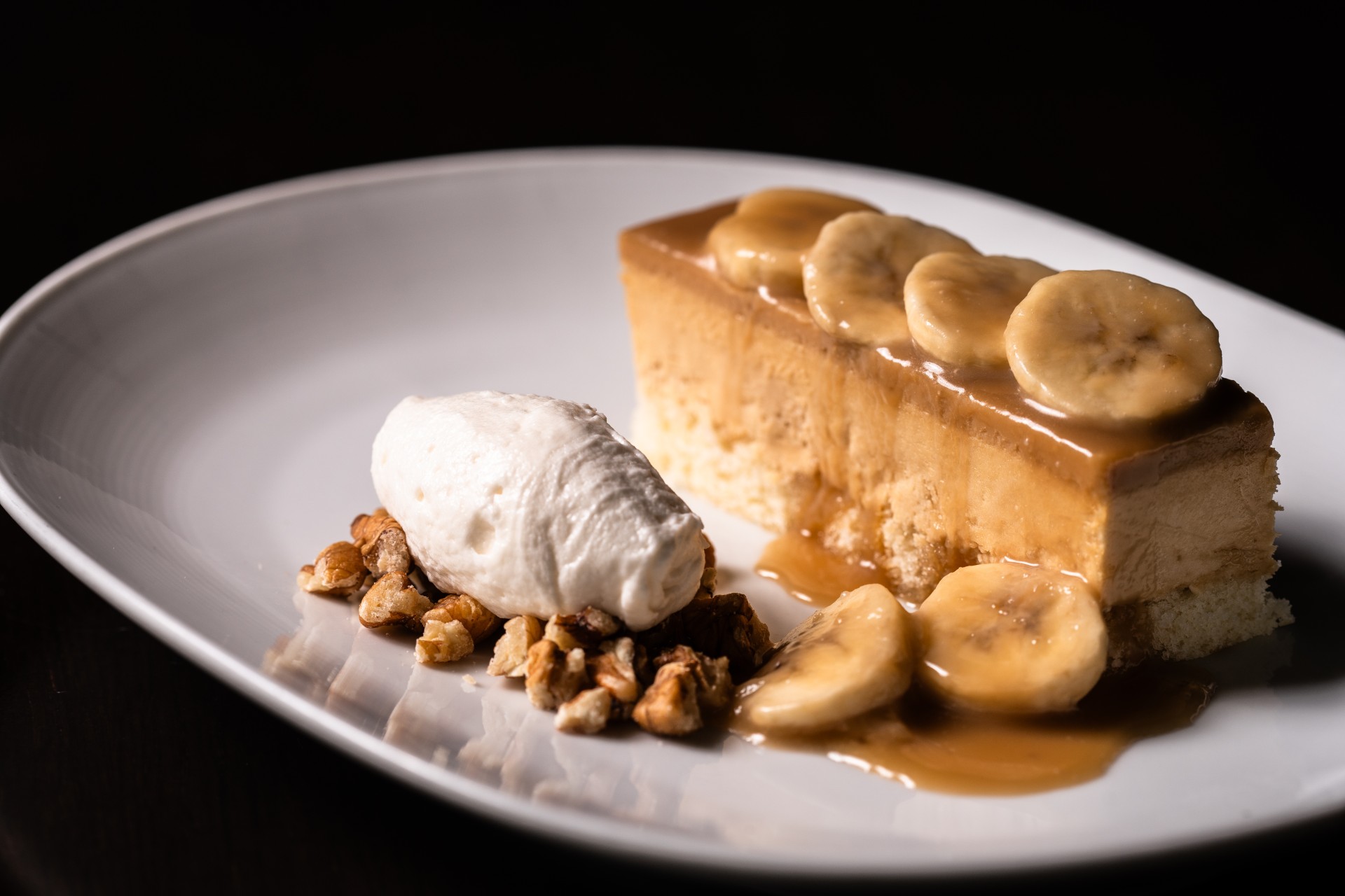 a plate of dessert with bananas and nuts