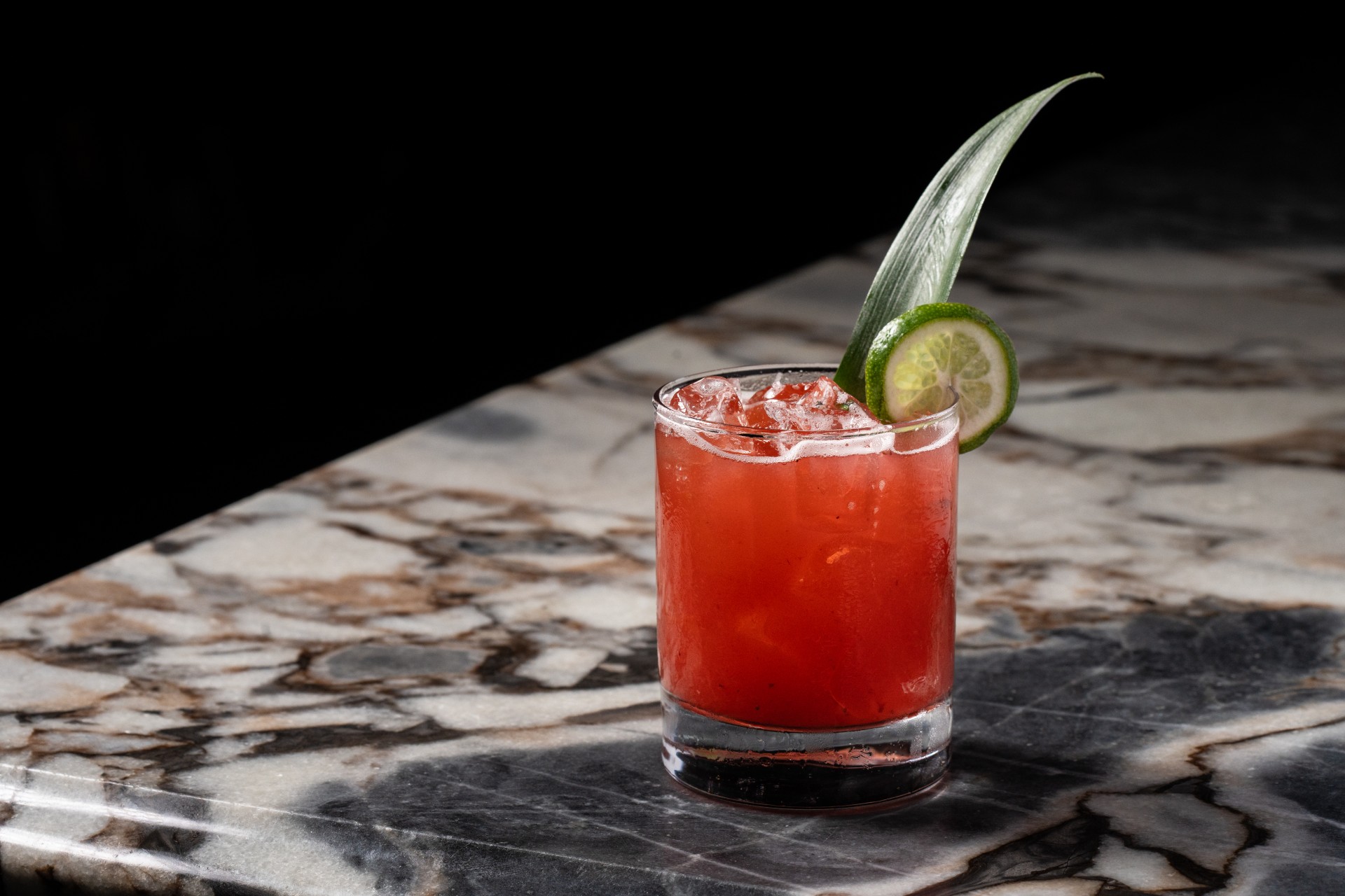 a drink with a leaf on top of it