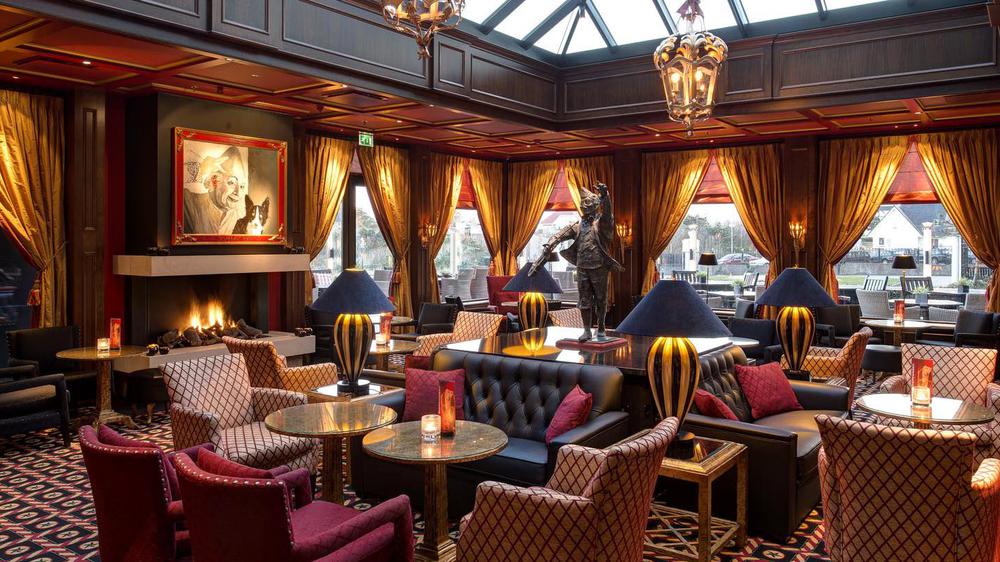 a room with tables and chairs and a statue of a man playing a saxophone