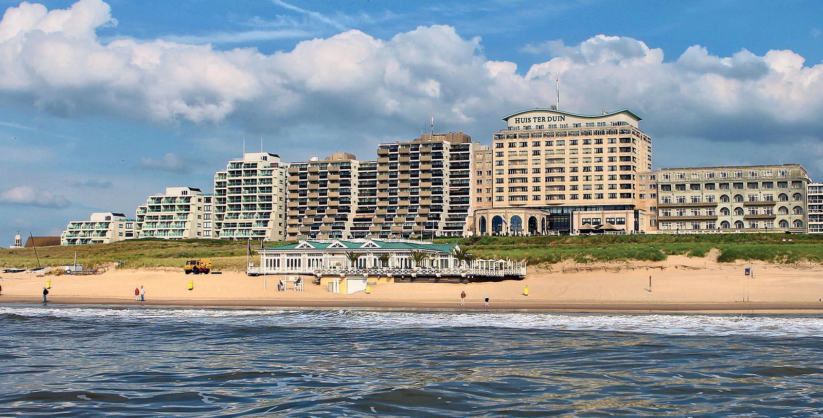 a beach with buildings and a body of water
