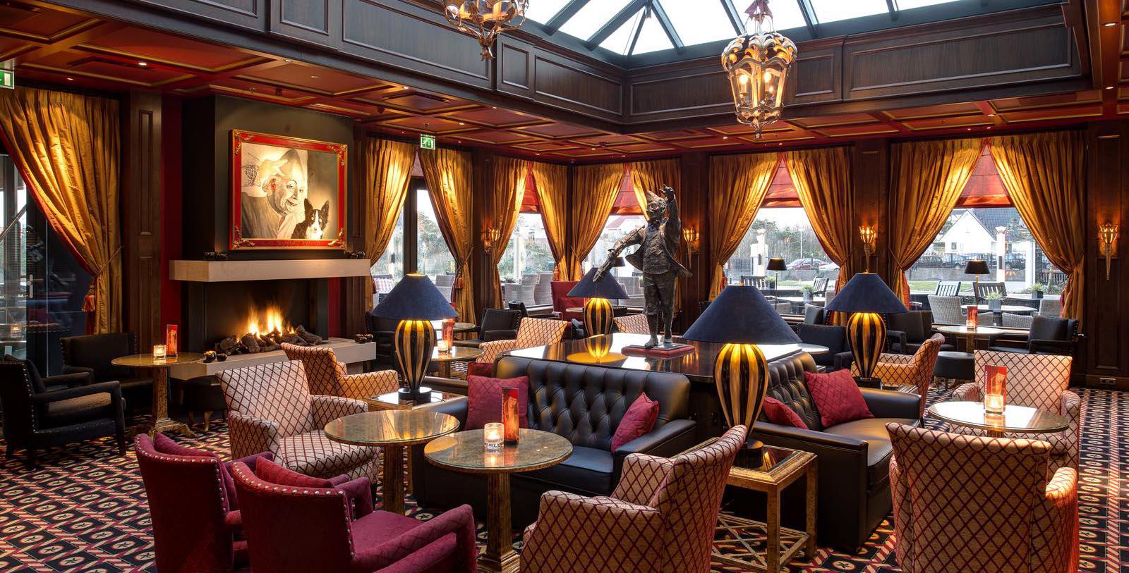 a room with a statue and tables and chairs