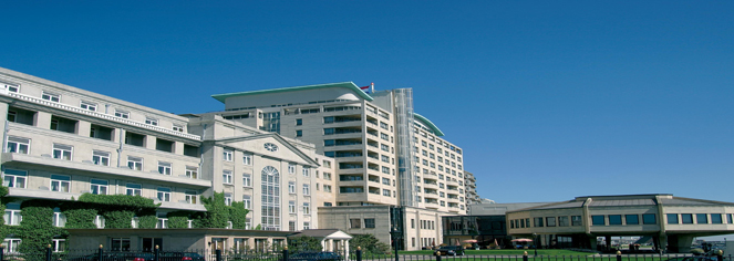 a large white building with green roof