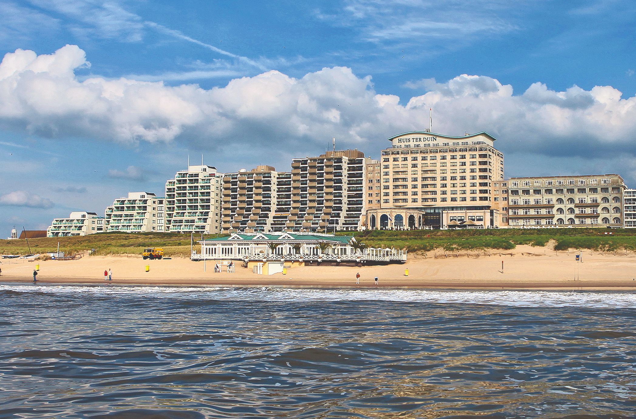 a beach with buildings and a body of water