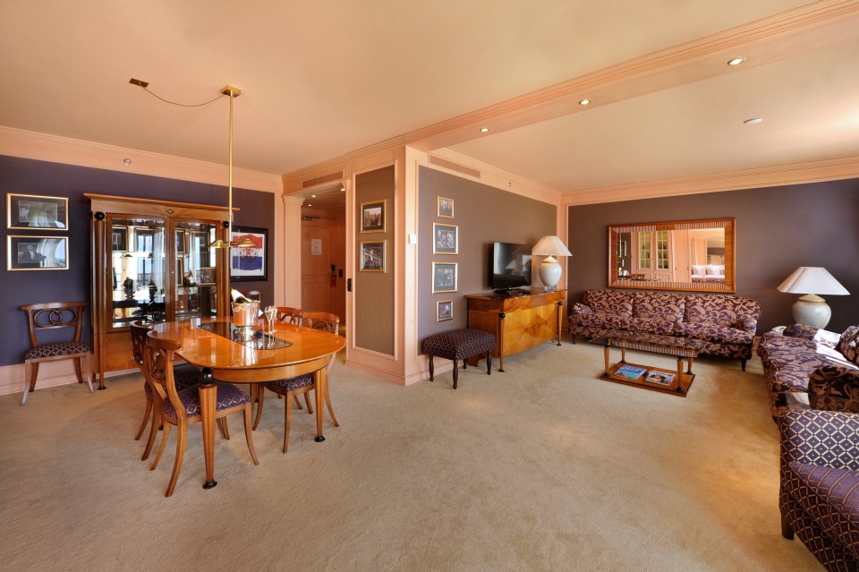 a living room with a table and chairs
