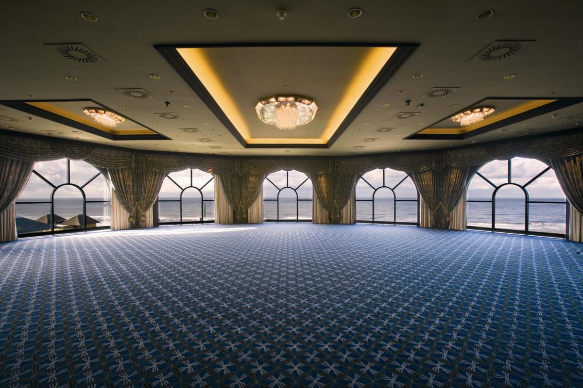 a large room with windows and curtains