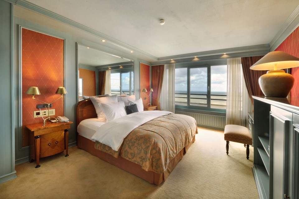 a bedroom with a large mirror and a bed
