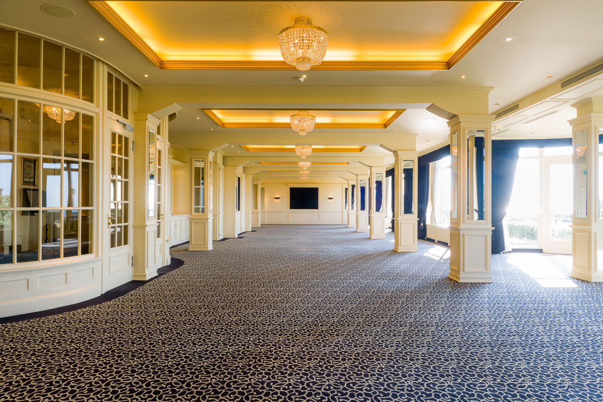a large room with chandeliers and a black carpet