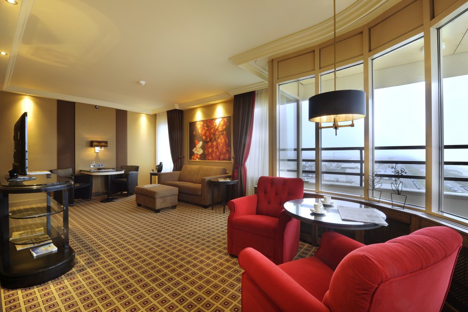 a room with red chairs and a table