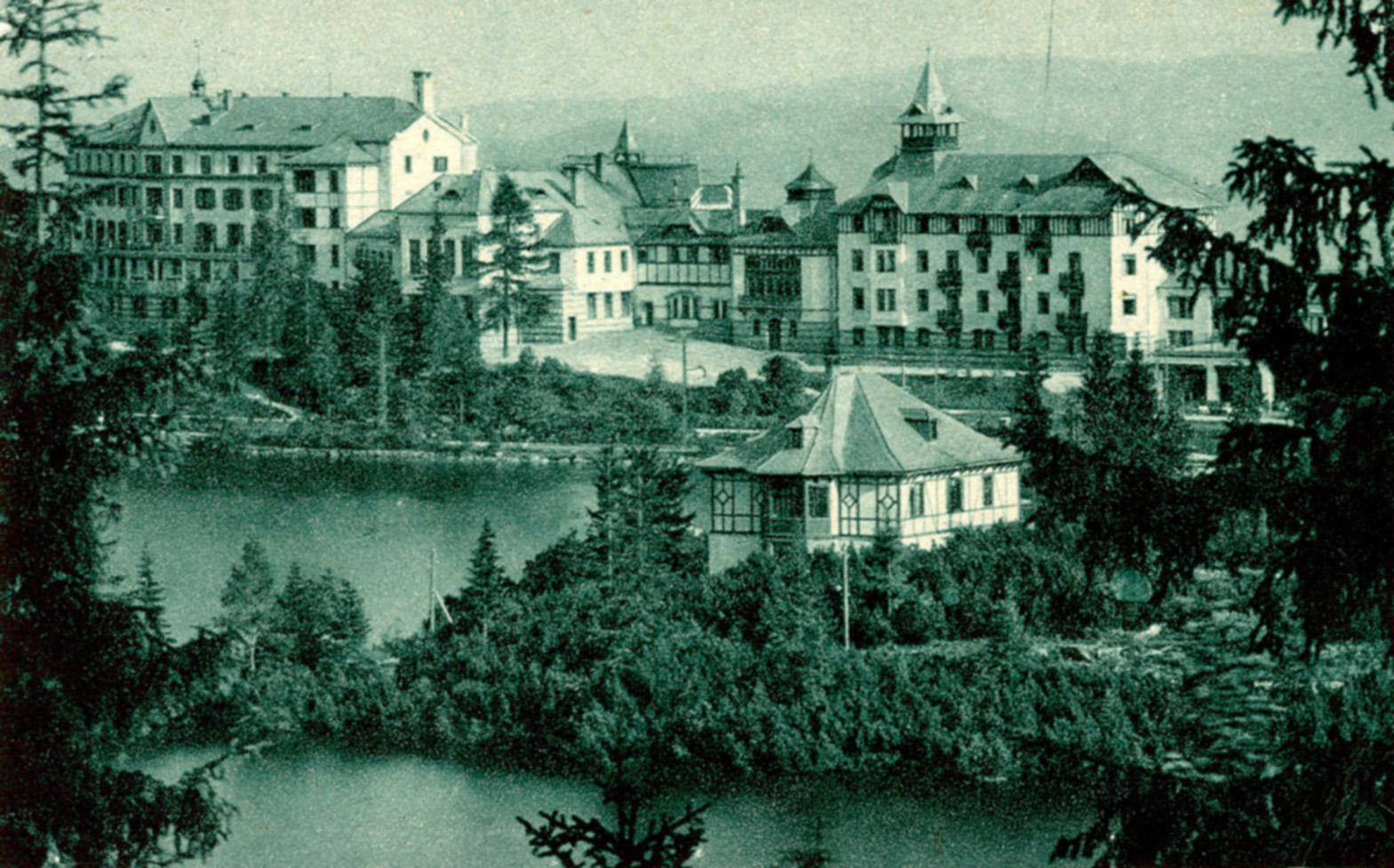 a group of buildings next to a lake