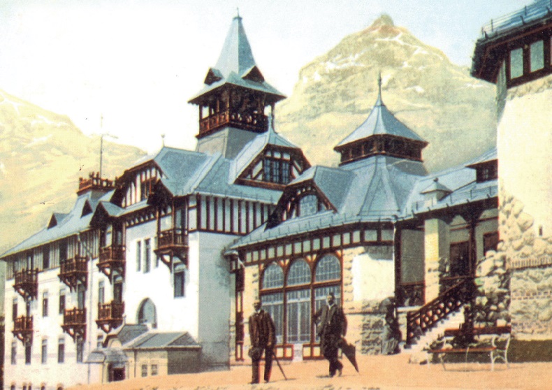 a building with a steeple and a couple of people standing outside