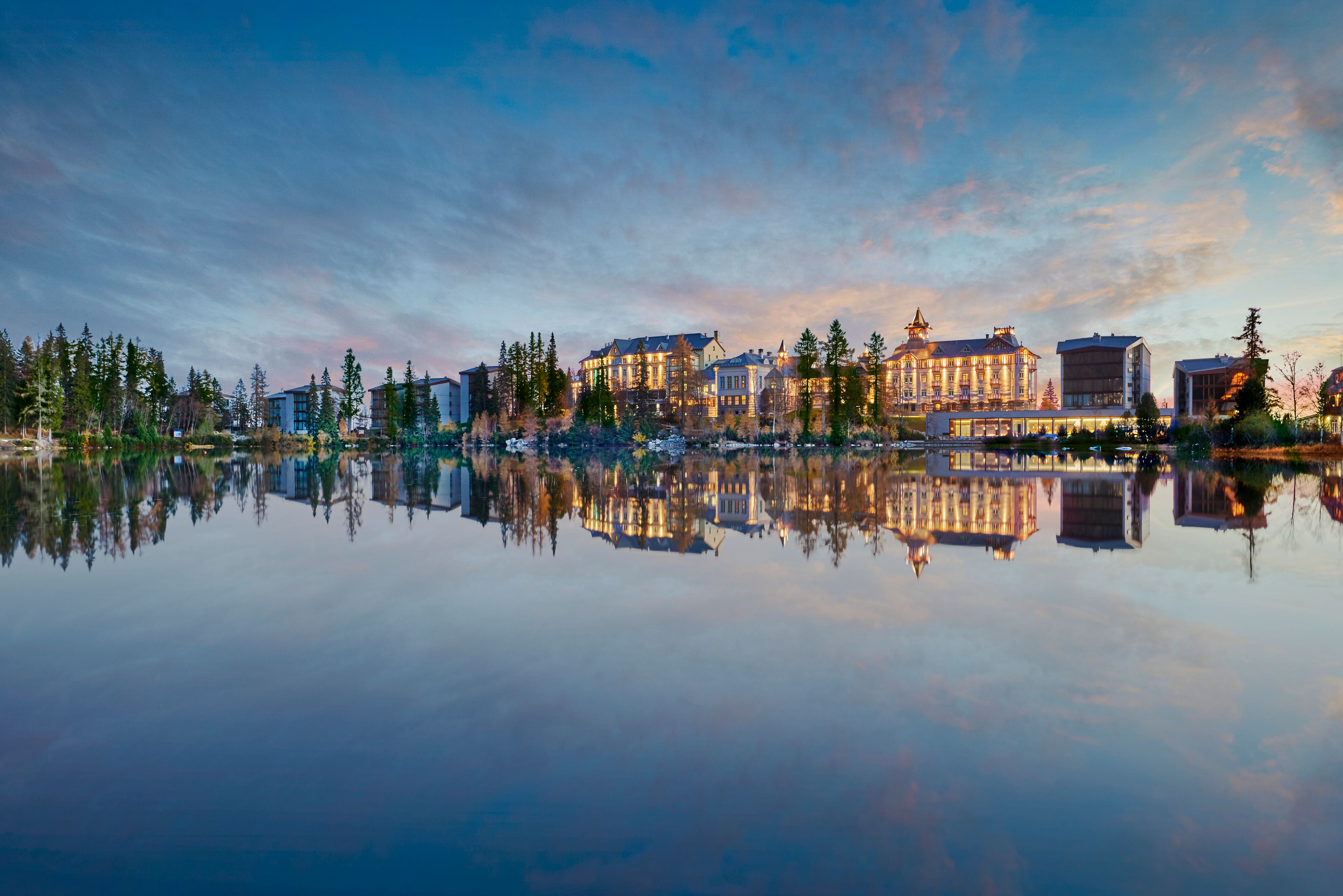 a city with lights reflecting on water