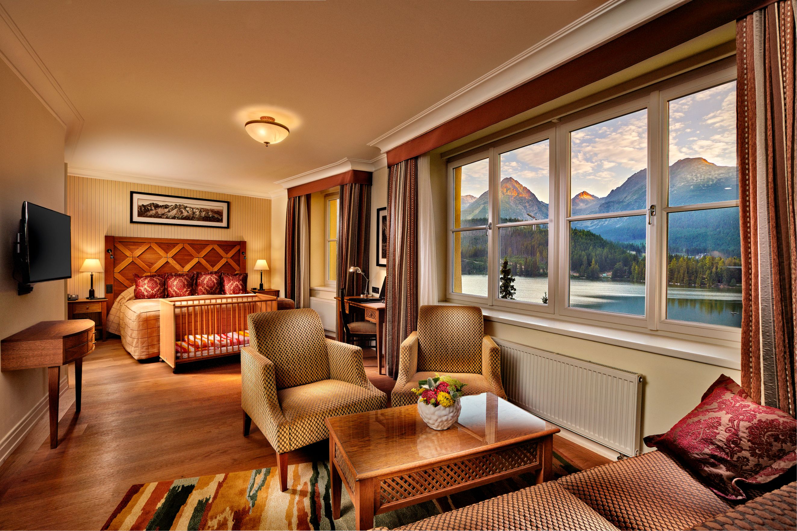 a room with a bed and chairs