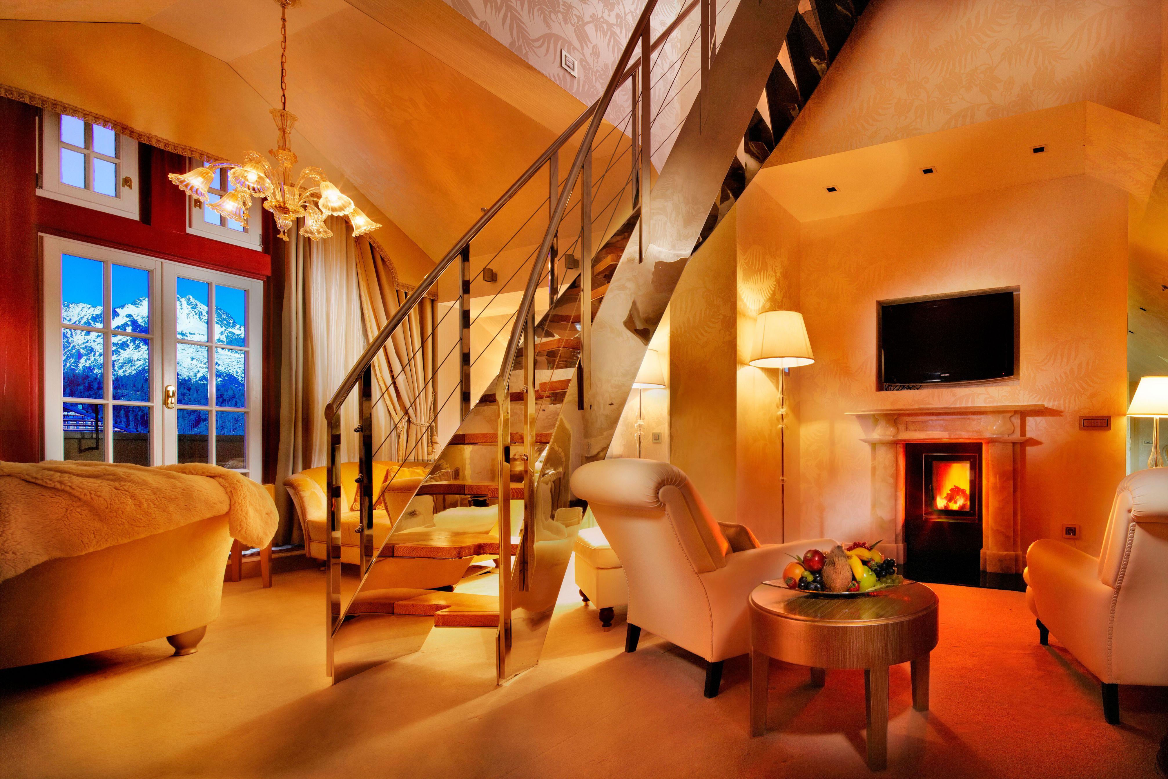 a living room with a staircase and a fireplace