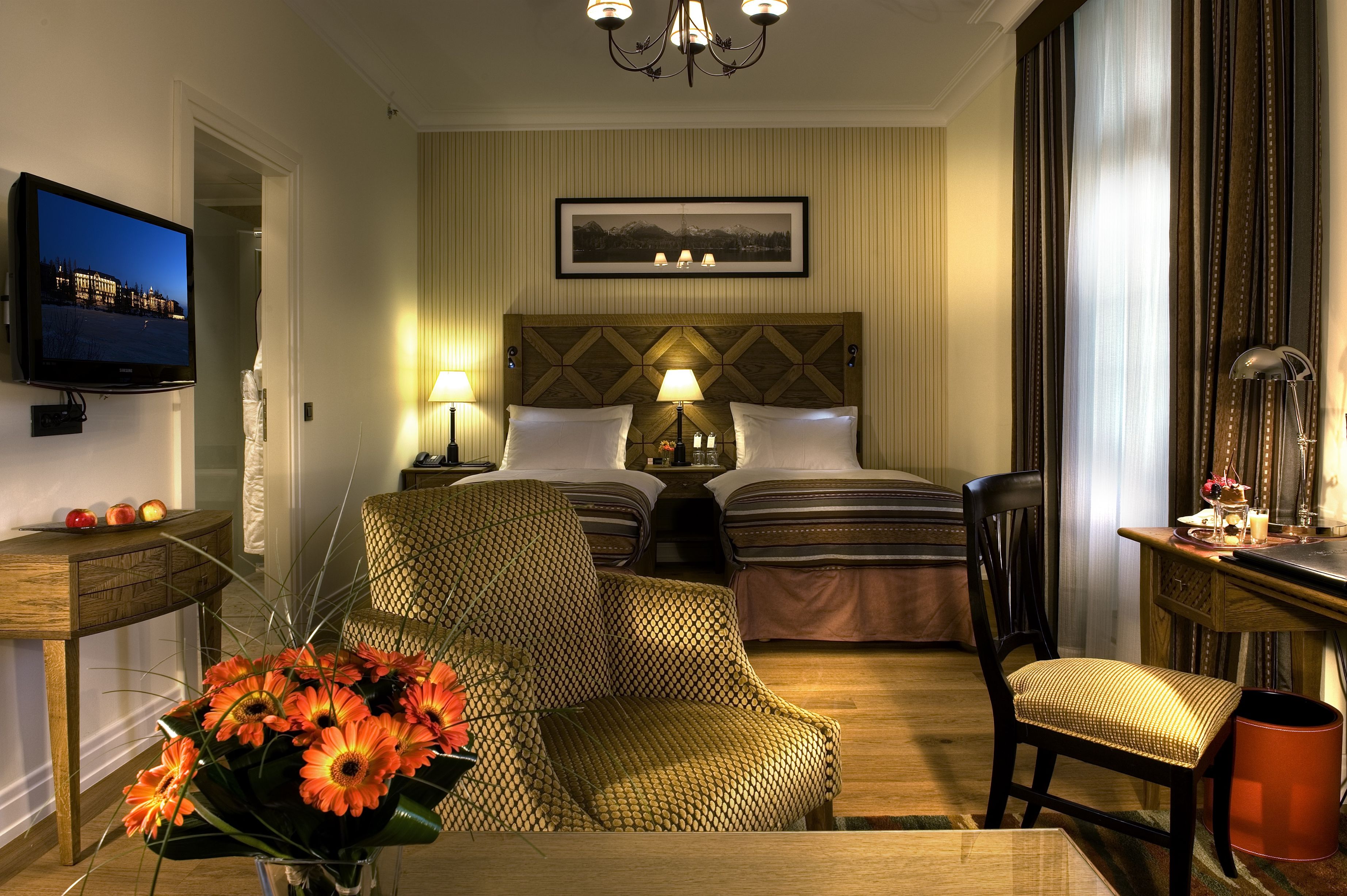 a room with two beds and a chandelier