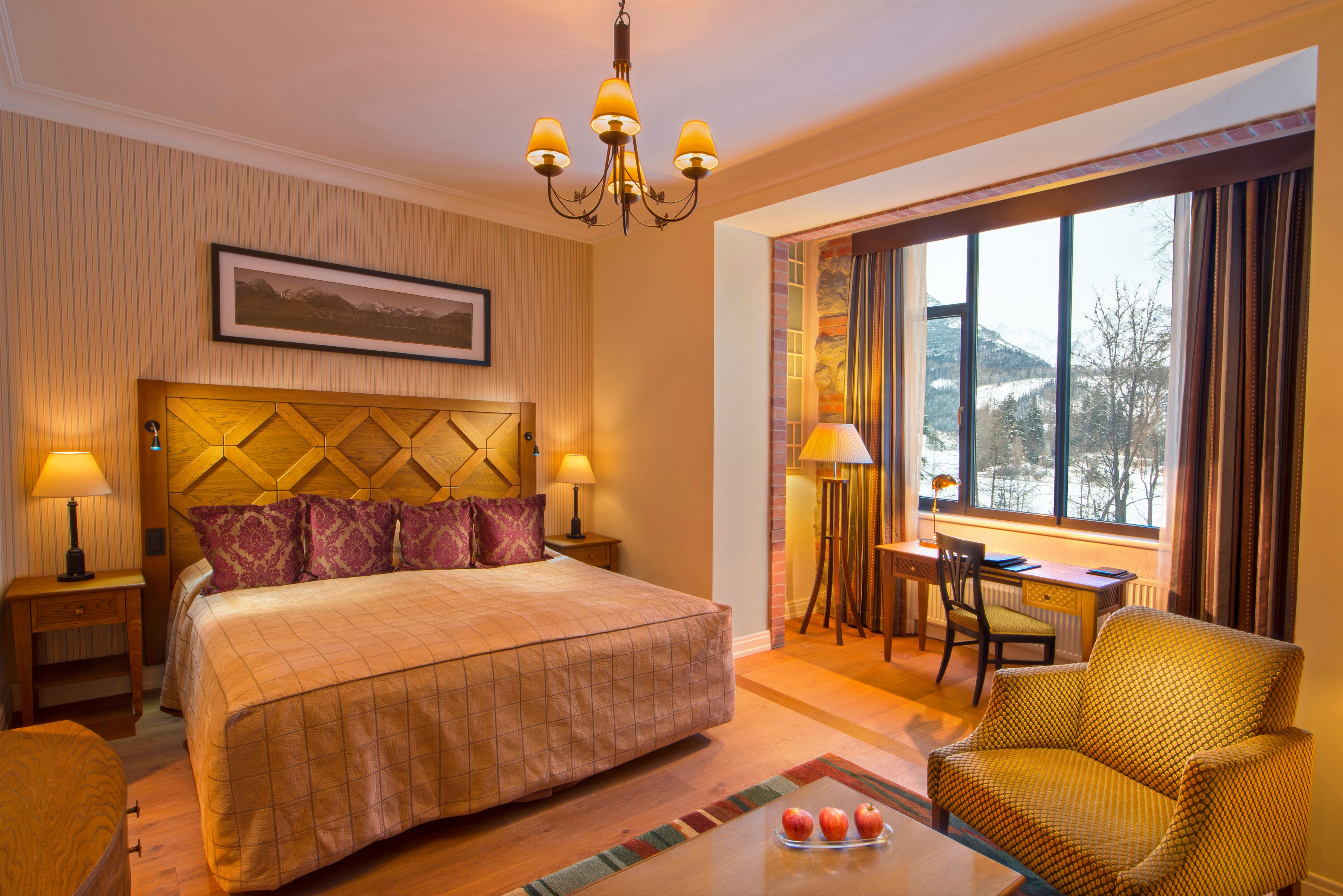 a room with a bed and a chair and a desk